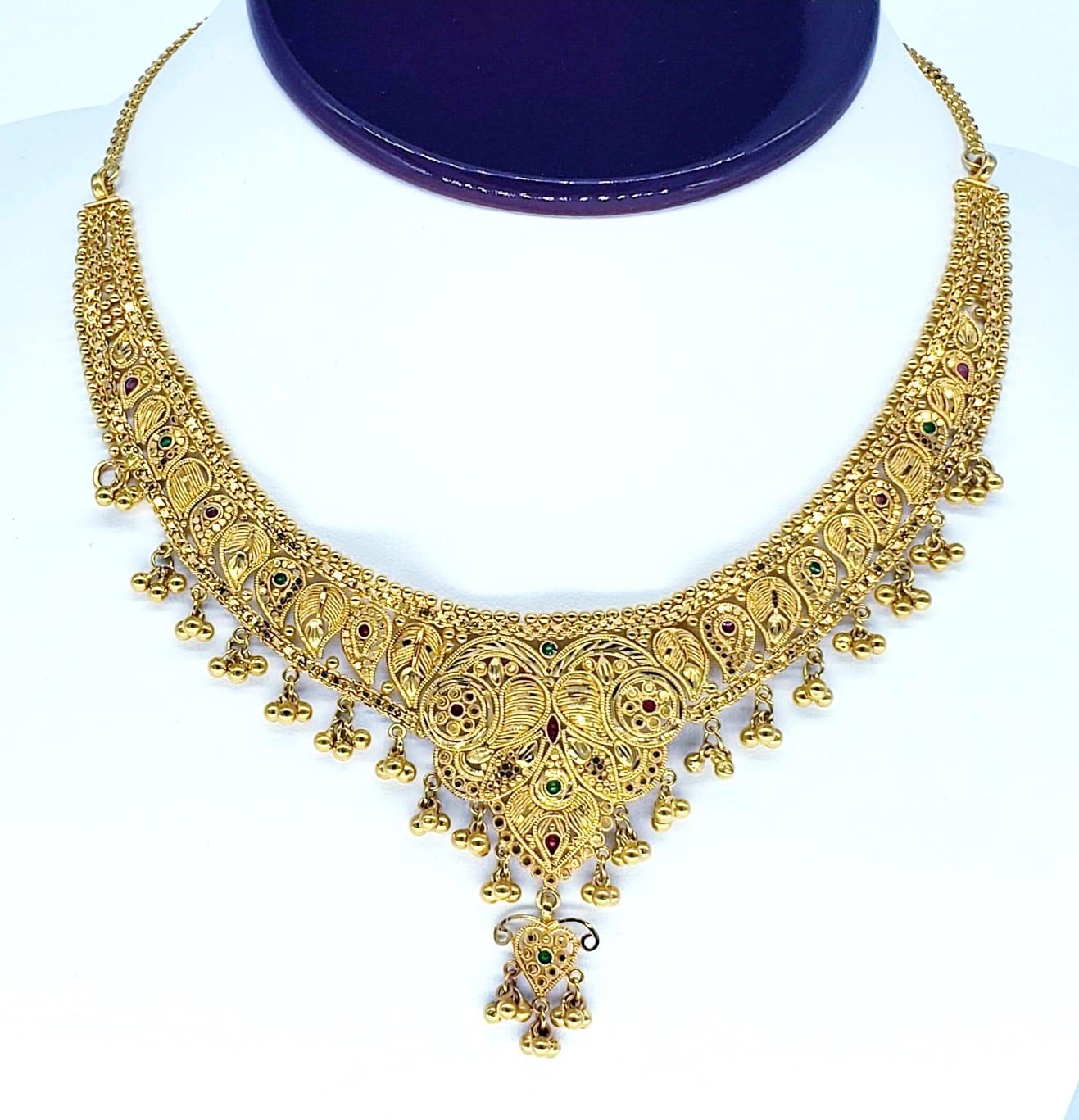 22k Traditional Royal Wedding Necklace. The necklace weights 35.7 grams 22k gold. The length is 16 inches and measures 6” By 2.5”