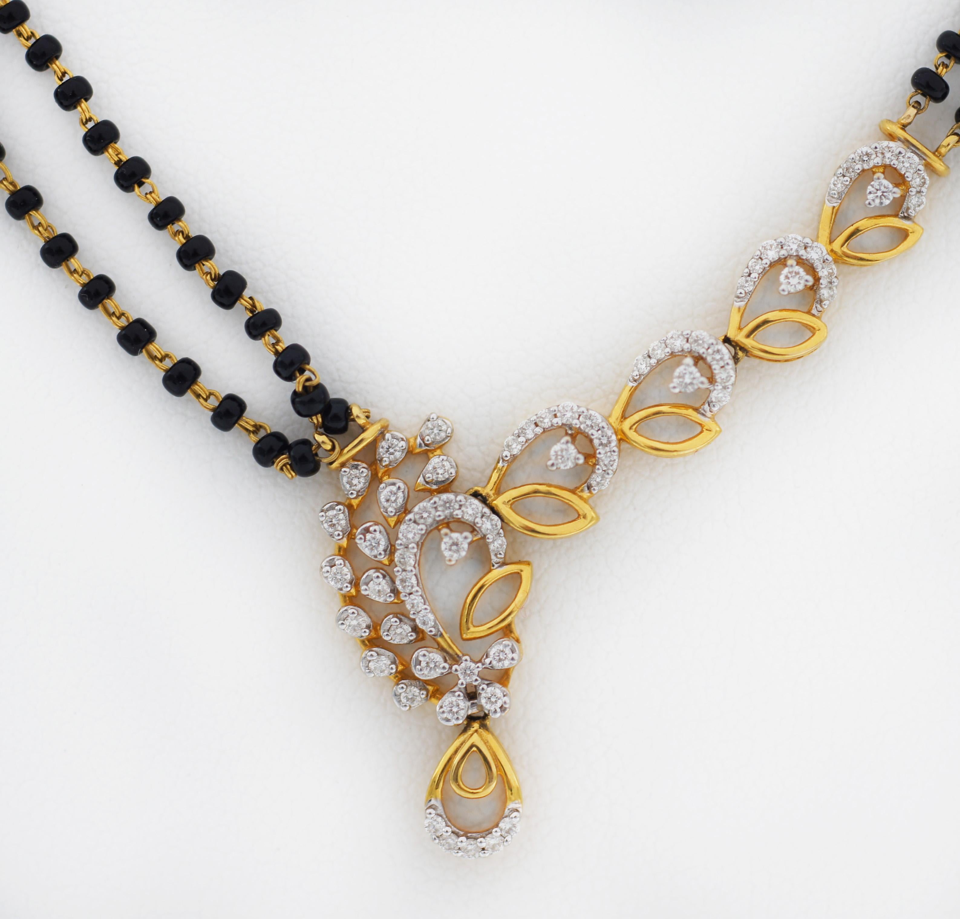 Graceful and timeless, this mangalsutra elegantly captures the essence of a sacred bond.
A symphony of black beads and diamond embedded in gold.
Made in Indian 22K Gold
With Diamond Pendant
and 2 strand Black beads chain
Necklace approx. up to 18