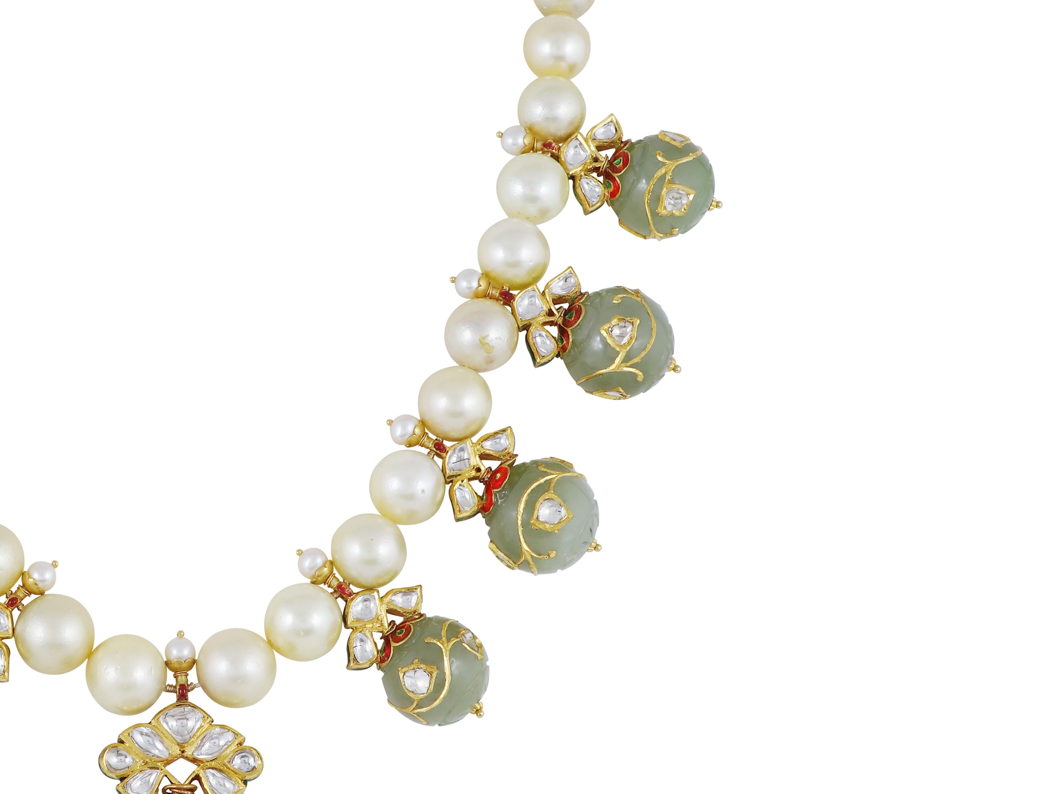 A necklace of rare celadon nephrite jade balls, collected over a time period of 3-4 years. Each ball is beautifully carved and then meticulously inlaid with 24K gold and diamond polkis. The balls are then suspended from 22K gold caps which are