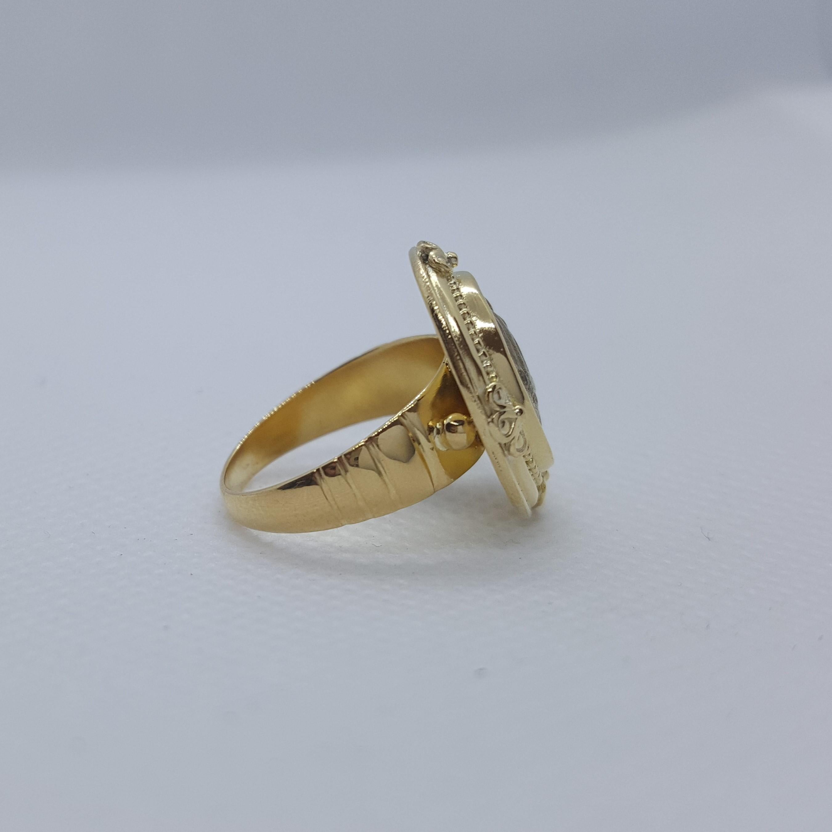 Beautiful unique 22kt yellow gold bezel ring holding an ancient Greek coin. The top bezel is a unique beaded design that's 19mm in width; the shank of the ring is 6.5mm tapering to 2.5mm, 4.4mm thick and stamped 22K. The size of the ring is 6.75. 