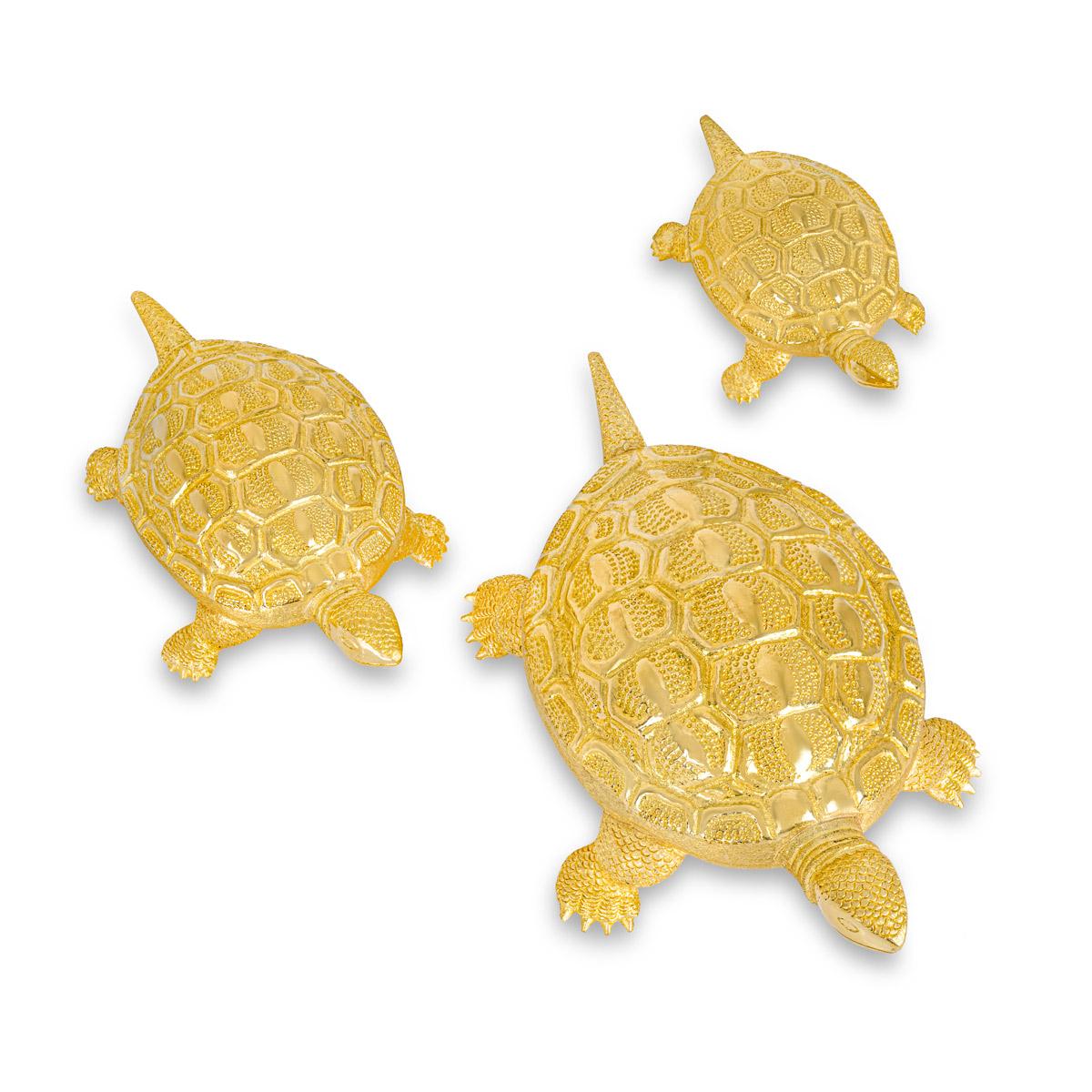 A charming set of three turtles set in 22k yellow gold. The family of turtles consist of large, medium and small turtles. The large turtle measures 7.9mm in length, 4.1mm in width, 2.5mm in depth and has a gross weight of 56.35 grams. The medium
