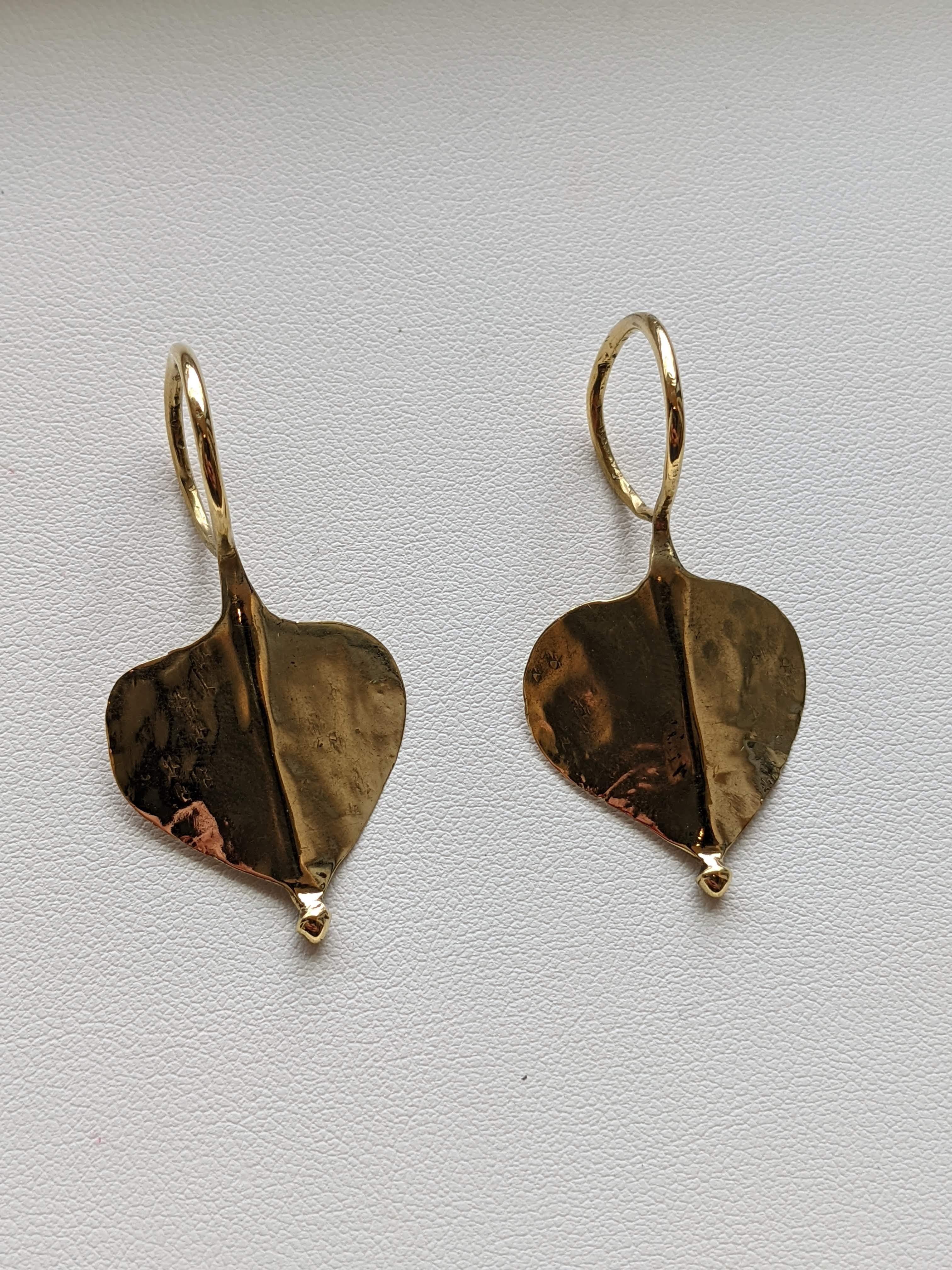These pretty leaf shaped earrings are made entirely from 22k yellow gold, hence their beautiful rich yellow colour. These authentic antique earrings from India are a lovely shape and have a handcrafted look to them. They have rounded hooks that are
