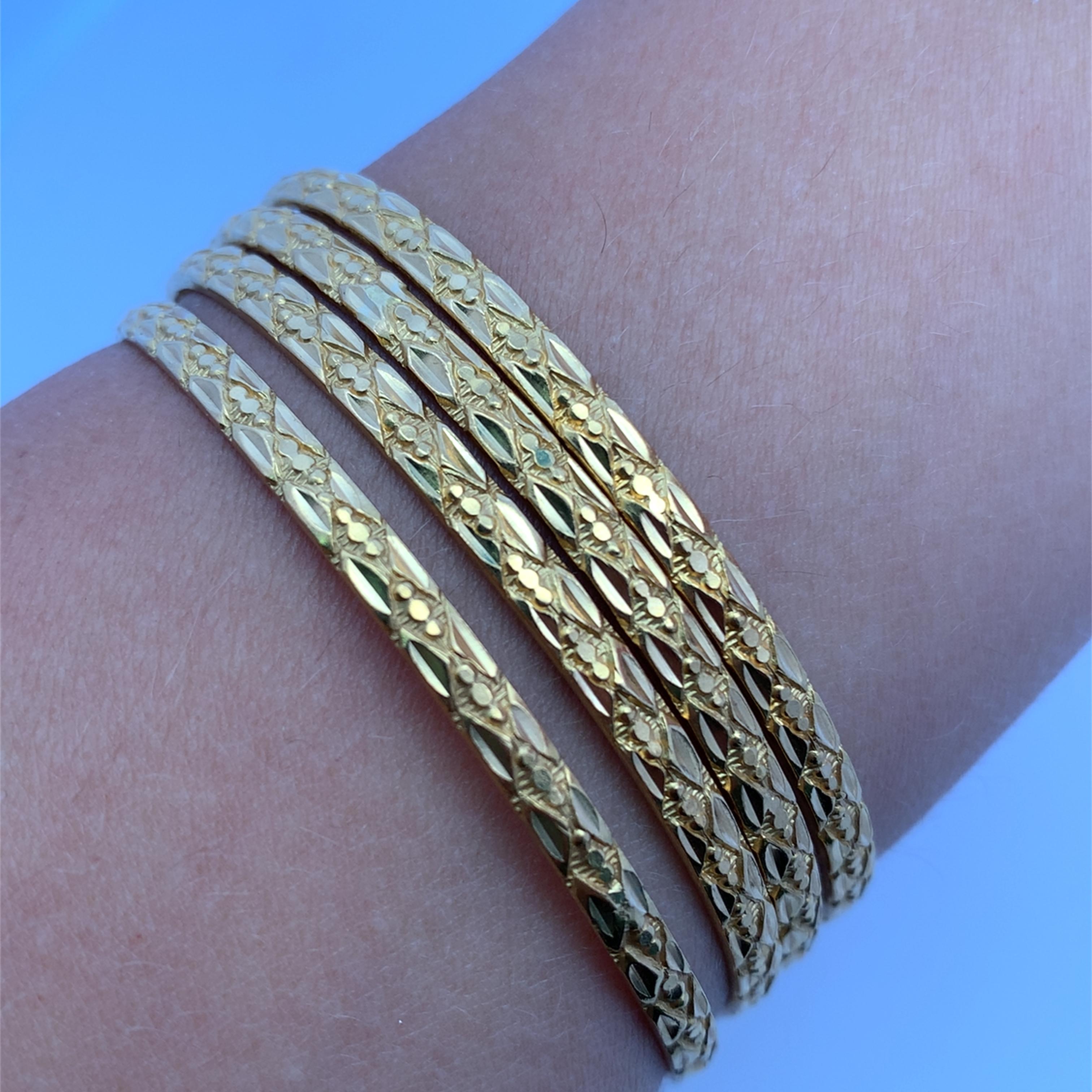 Elevate your style with this radiant 22k yellow chunky patterned gold bangle. Delicately etched with intricate patterns, this polished piece adds a touch of timeless elegance to any ensemble. Its smooth, comfortable fit ensures you can wear this