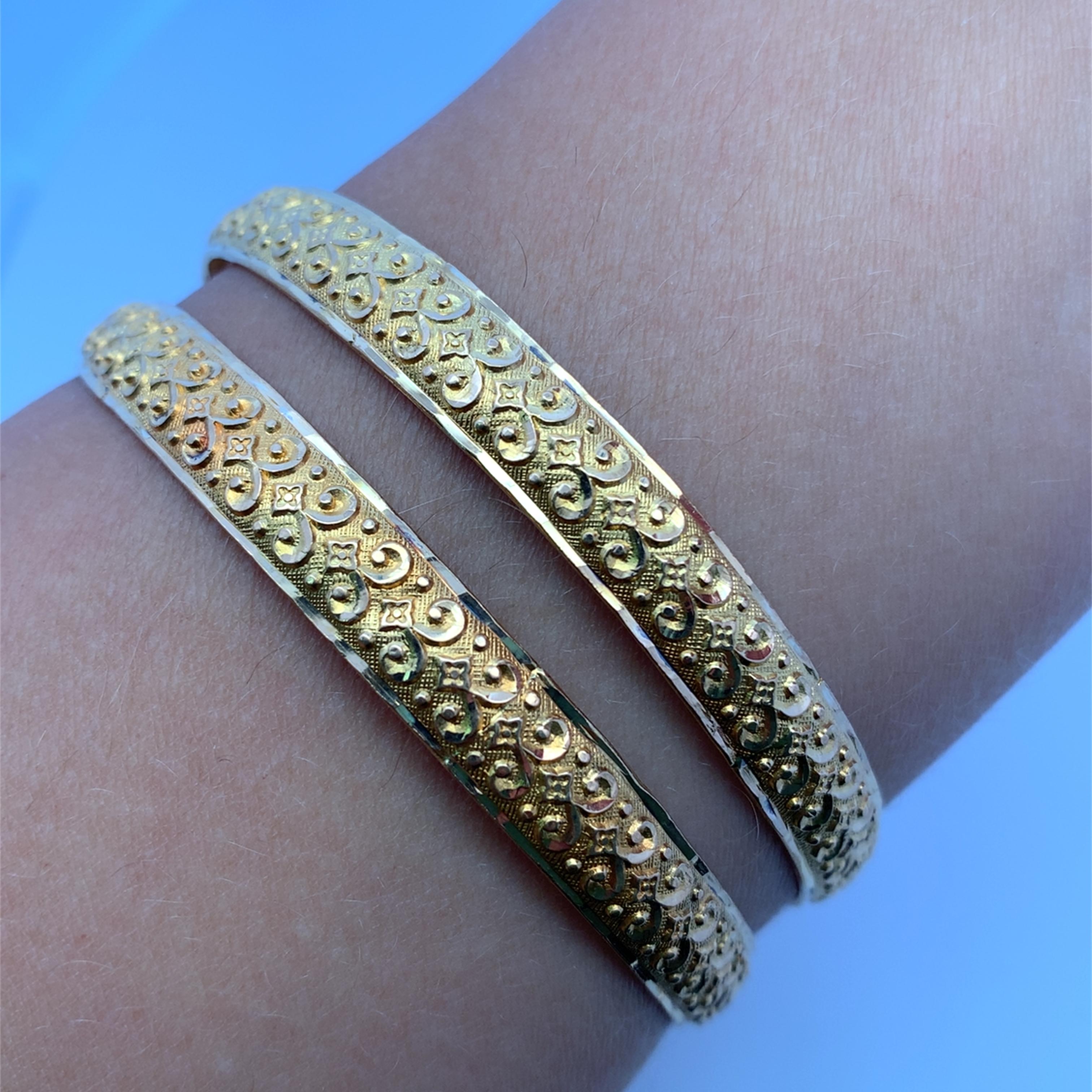 Elevate your ensemble with this exquisite 22k yellow gold bangle, an emblem of refined taste. The seamless fusion of traditional craftsmanship and timeless elegance renders this bangle a must-have adornment for any jewelry aficionado. Its lustrous