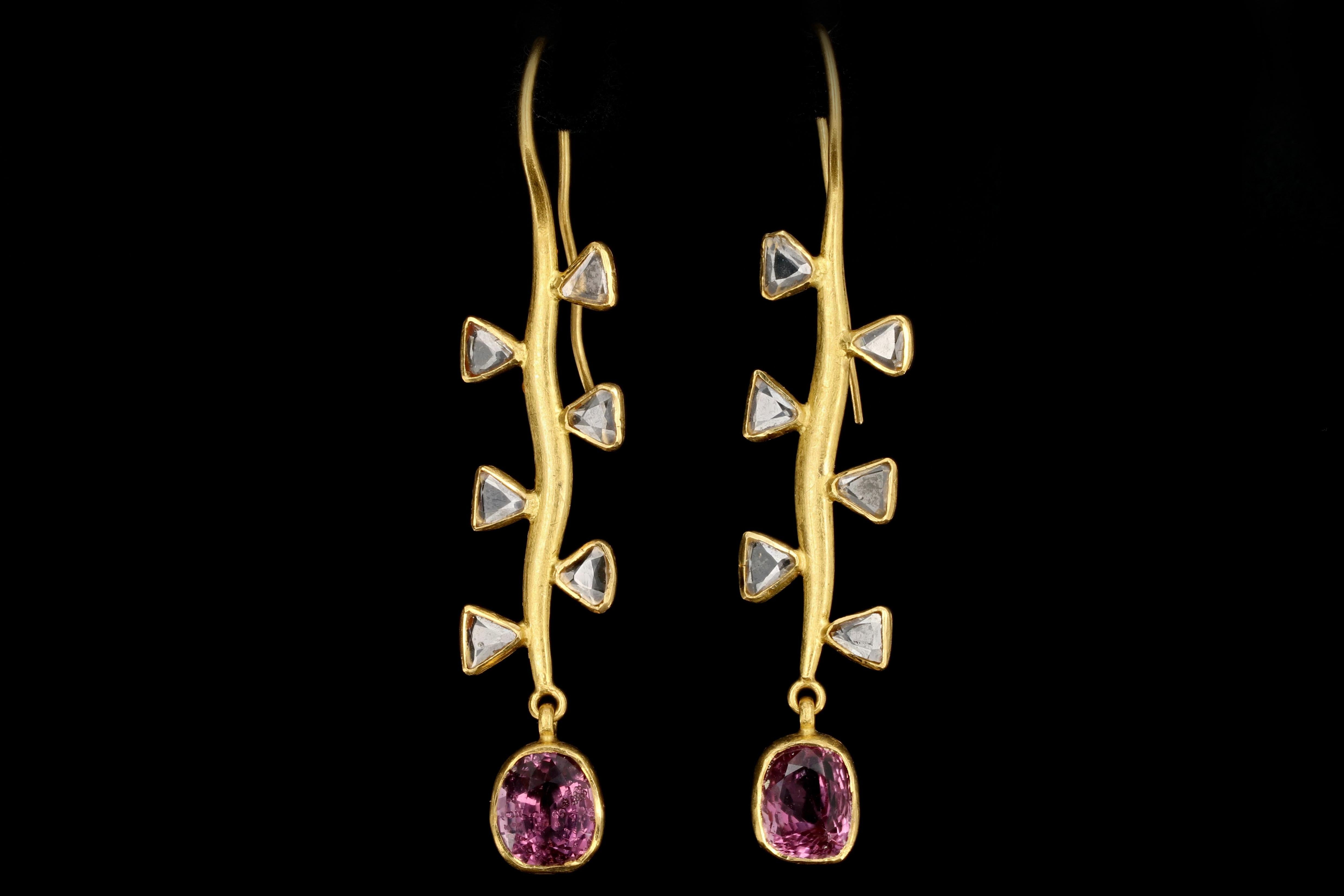 Era: Modern

Composition: 22K Yellow Gold

Primary Stone: Pink Spinel

Spinel Carat weight: 2.45 Carats & 2.74 Carats

Total Spinel Carat Weight: Approximately 5.2 Carats

Accent Stone: Trillion Rose Cut Diamonds

Trillion Cut Diamond Measurements: