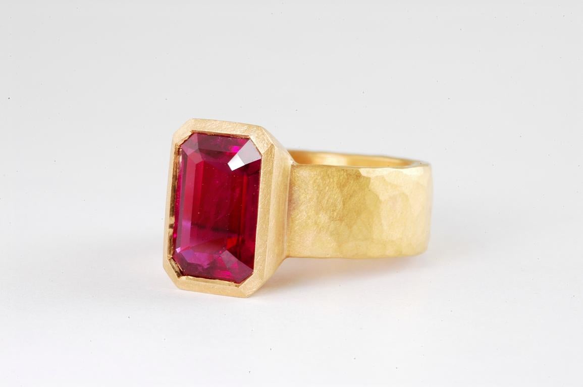 22ct gold 6mm flat hammered ring set with step cut  ruby 4.17cts handmade in Notting Hill London by British jewellery designer Malcolm Betts. This ruby set in 22Karat gold embodies the ancient creations of years passed- a beautiful red ruby embedded