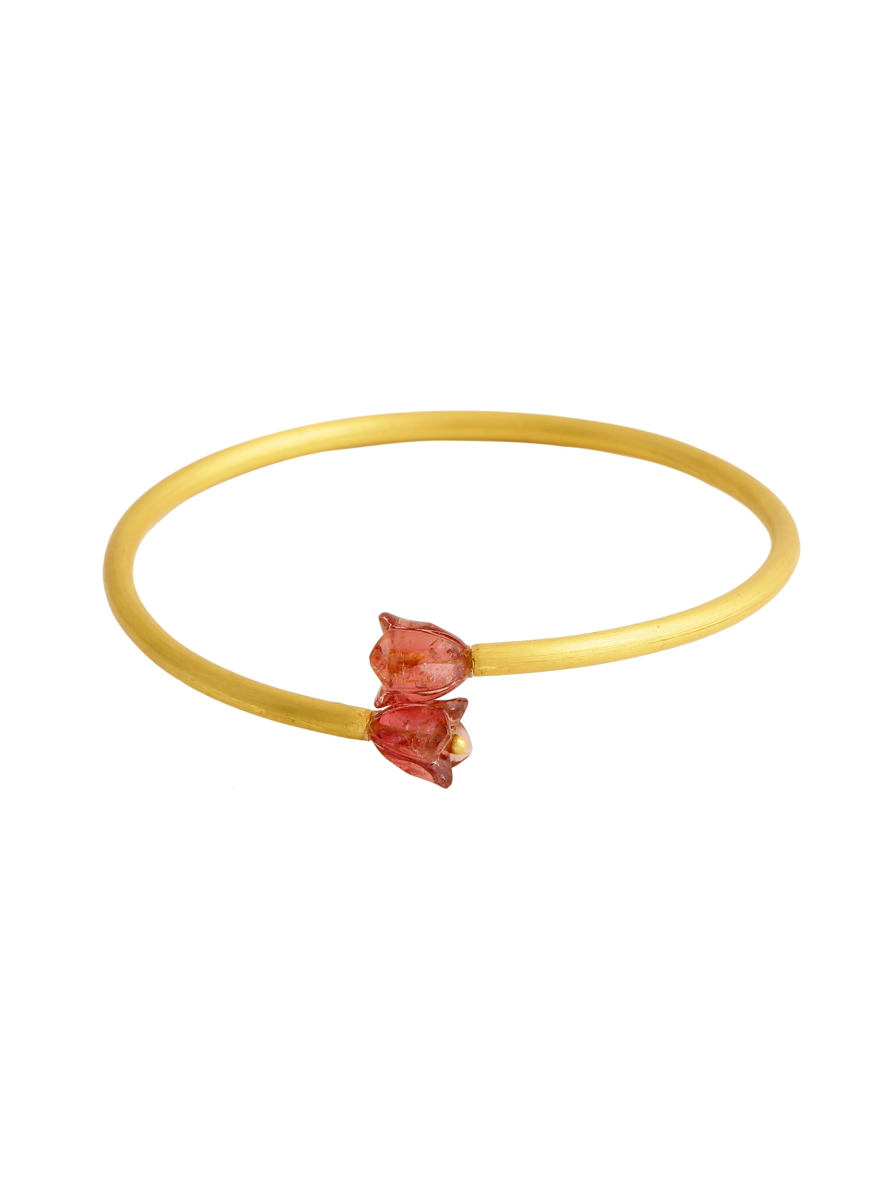 A beautiful bangle handcrafted in 22 karat gold with a nice pair of tourmaline hand carved flower on both the ends.
The bangle fits and sits well on mostly all wrist sizes. Matte finish gold gives it a very unique look. Perfect as a part of your