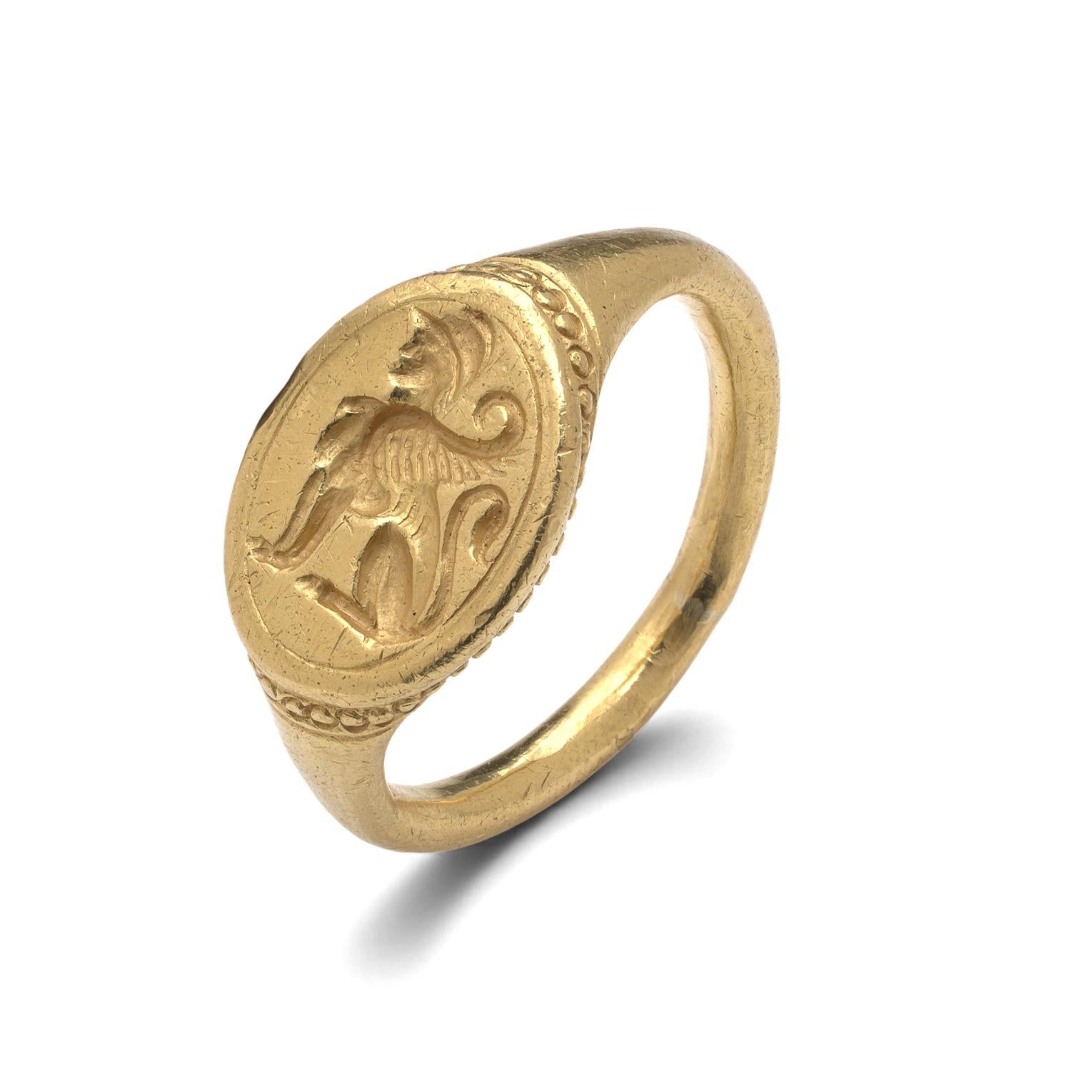 A rare antique gold signet ring finely crafted in high-purity 22KT gold and weighing 14.4 grams. The ring features an oval bezel deeply engraved with a griffon — a mythical creature symbolising strength, guardianship, and nobility. Likely produced