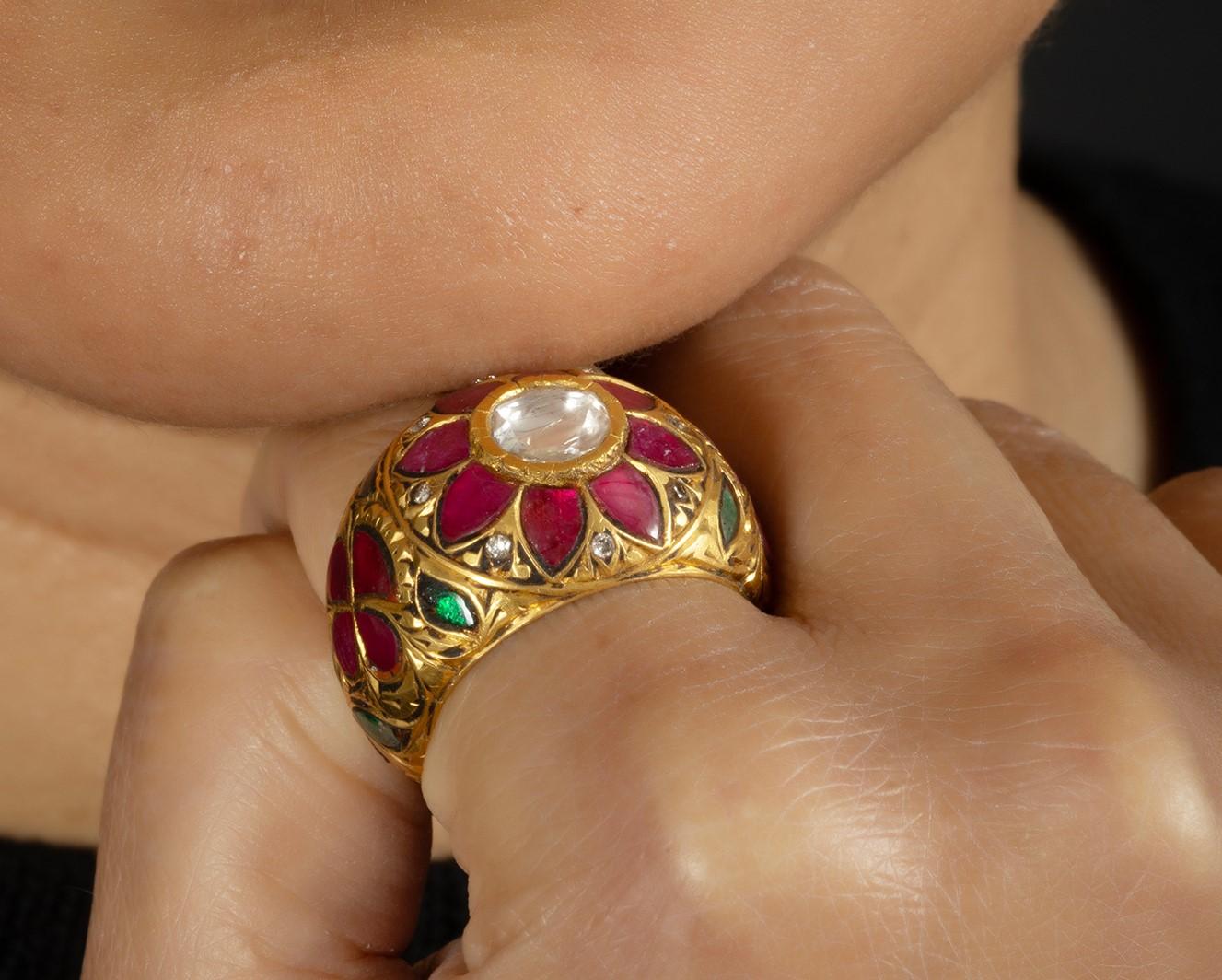 A very old technique of making jewellery blending the techniques of partash & kundan (the use of polki – uncut diamonds).

The ring is 8.620 grams of 22kt gold, 0.60 carat of high polki (uncut diamond ), 5.40 carat ruby & emerald.

The ring is 18mm