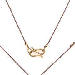 David Tishbi 22K Gold Buddha Charm On Brown Silk Cord