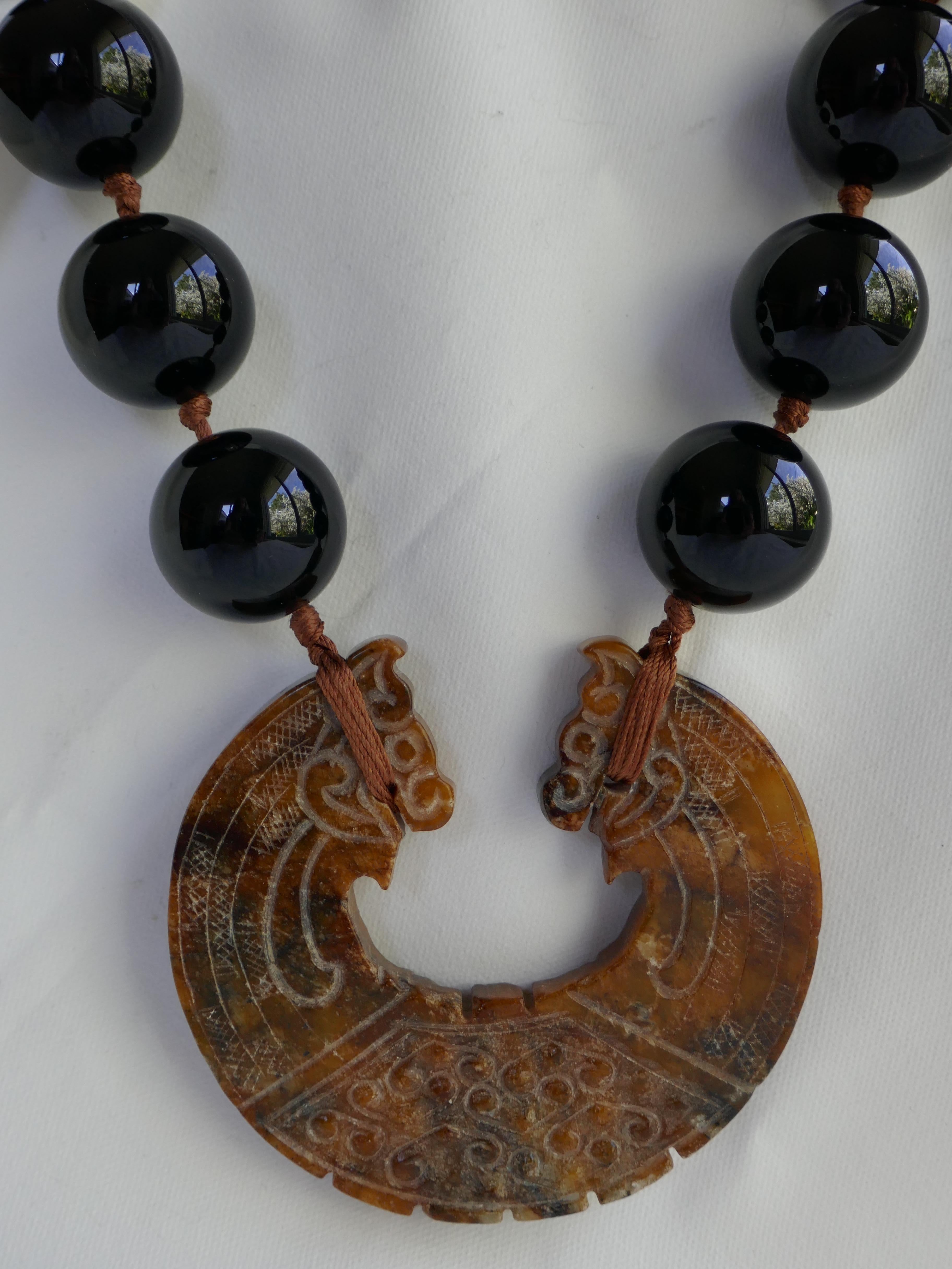 Onyx goes with everything. The onyx beads in this necklace are 22mm and looks amazing on. 22mm are not that readily available but I love the sheer statement on large round  beads. The jasper pendant is carved and the contrast with the black onyx is