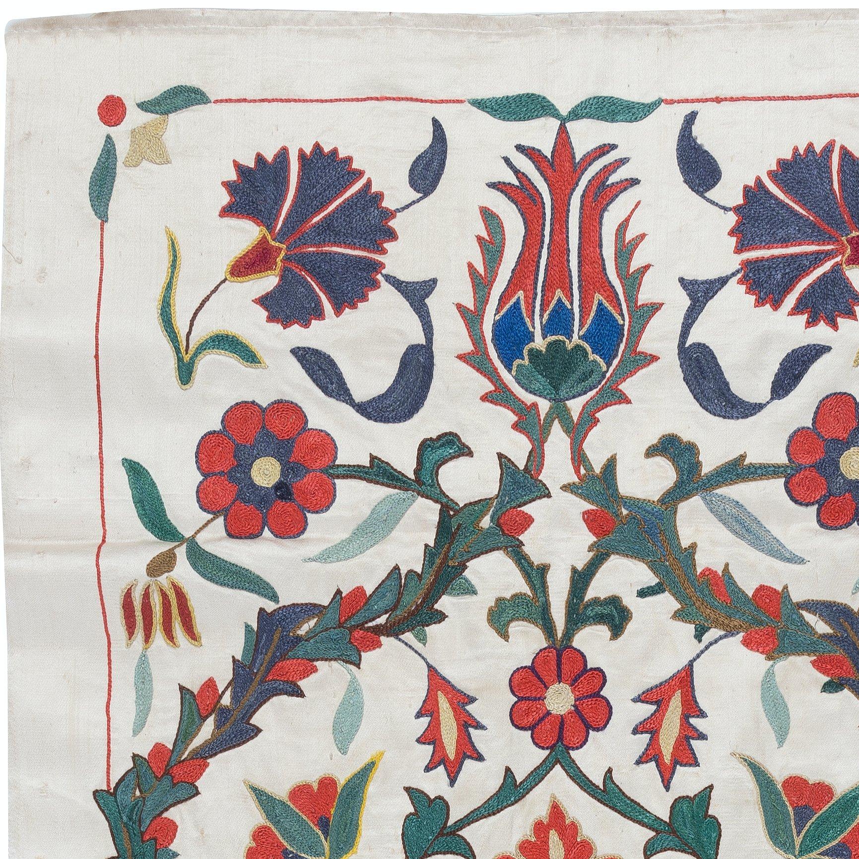 Introducing our exquisite Suzani Hand Embroidered 100% Silk Wall Hanging, a captivating piece that seamlessly blends artistry and functionality. This stunning decor item doubles as both a tapestry and a throw, making it perfect for adding an elegant