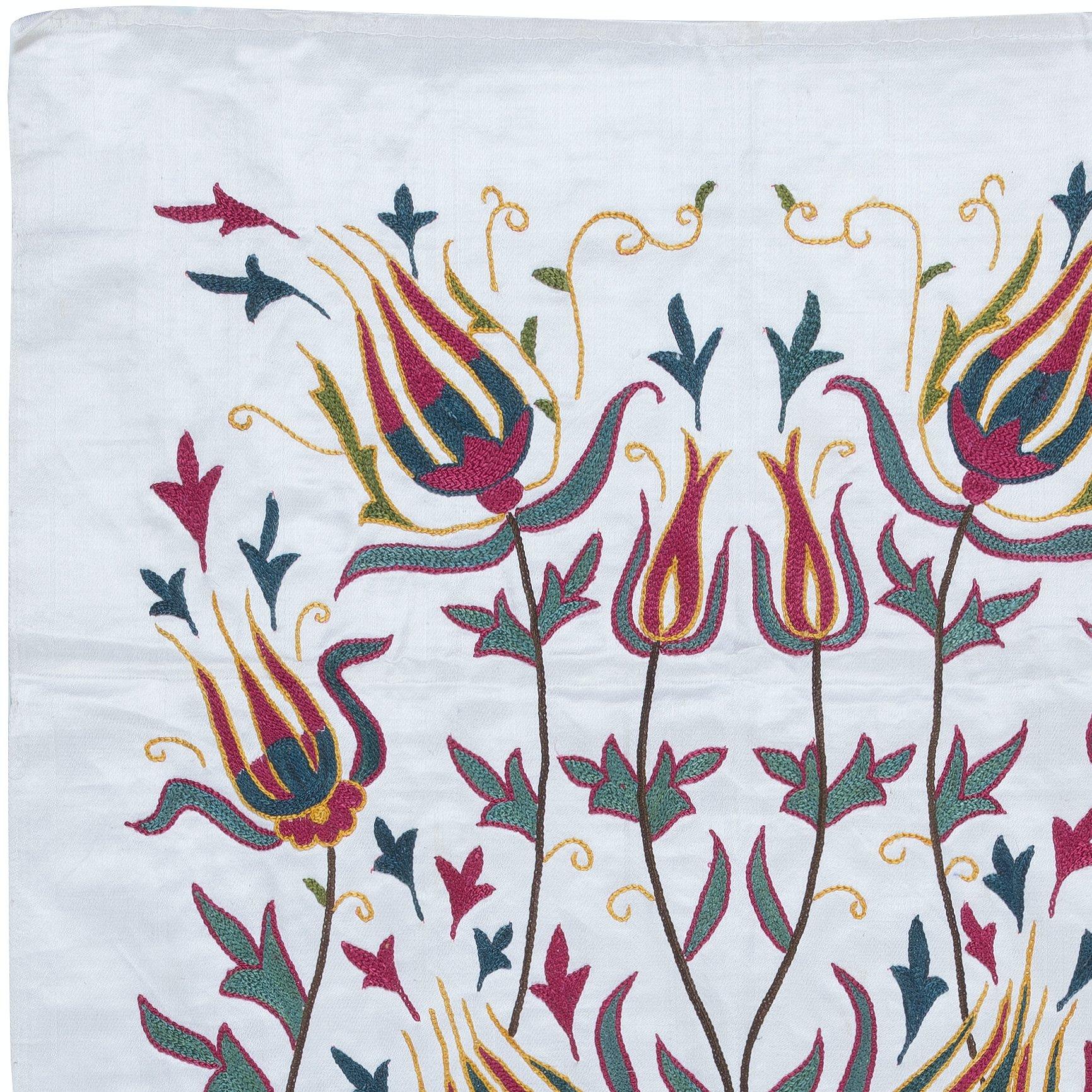 Introducing our exquisite Suzani Hand Embroidered 100% Silk Wall Hanging, a captivating piece that seamlessly blends artistry and functionality. This stunning decor item doubles as both a tapestry and a throw, making it perfect for adding an elegant