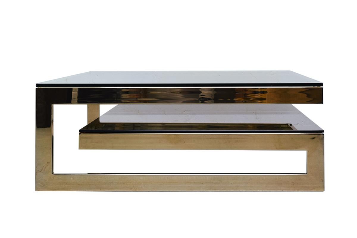 This luxurious square shaped coffee table is made of high quality 23-carat gold plated brass, manufactured by Belgo Chrome in Belgium in the 1970s. Also sometimes attributed to or in the style of Maison Jansen.

The base has a G-shape, allowing it