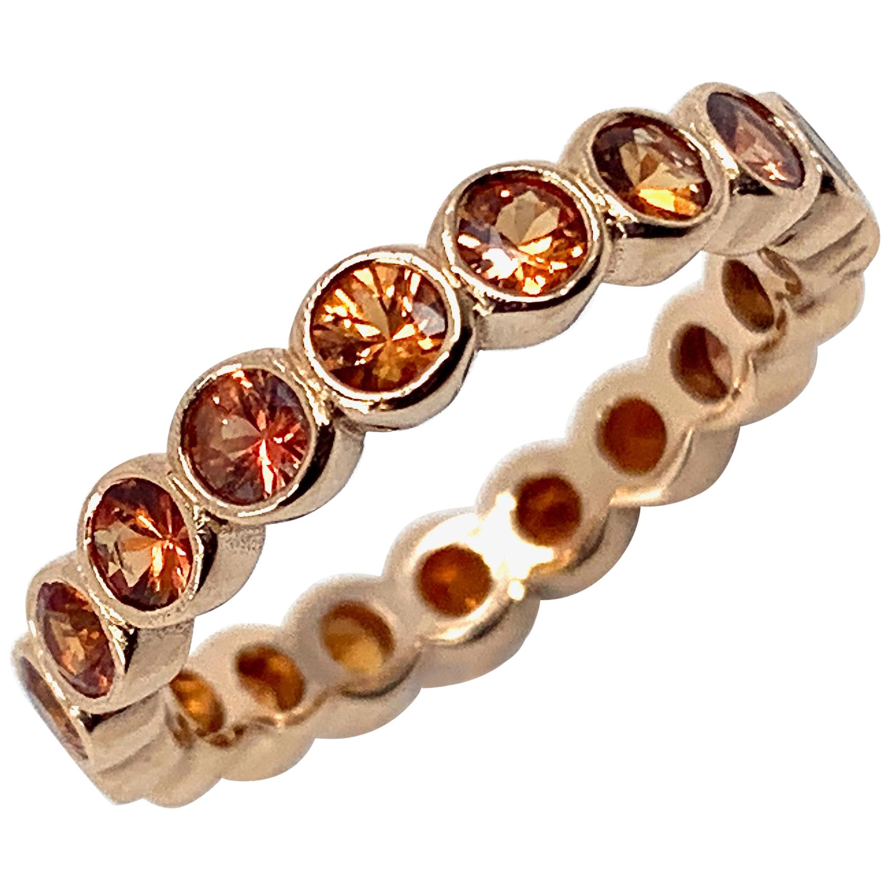Orange sapphires look great set in rose gold, and this presentation, by Eytan Brandes, is especially appealing -- 19 vivid hand-picked Tanzanian bird of paradise sapphires ranging from medium-light to dark orange are perfectly mounted in open-back