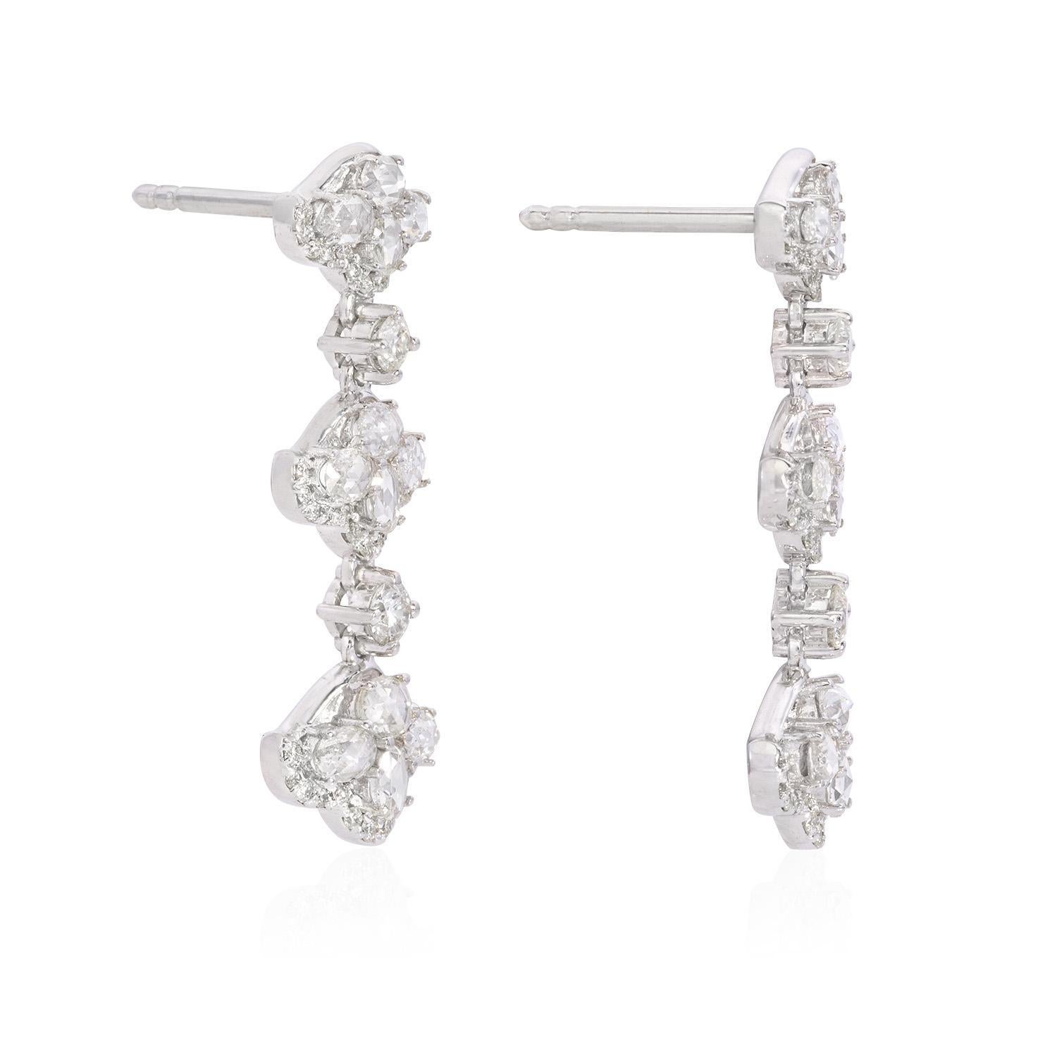 The drop earrings are a captivating creation featuring 1.6 carats of rose-cut white diamonds with VVS1 clarity and F color grade. Complemented by 0.79 carats of round-cut white diamonds, these earrings exhibit VS2 clarity and F color grade. Crafted