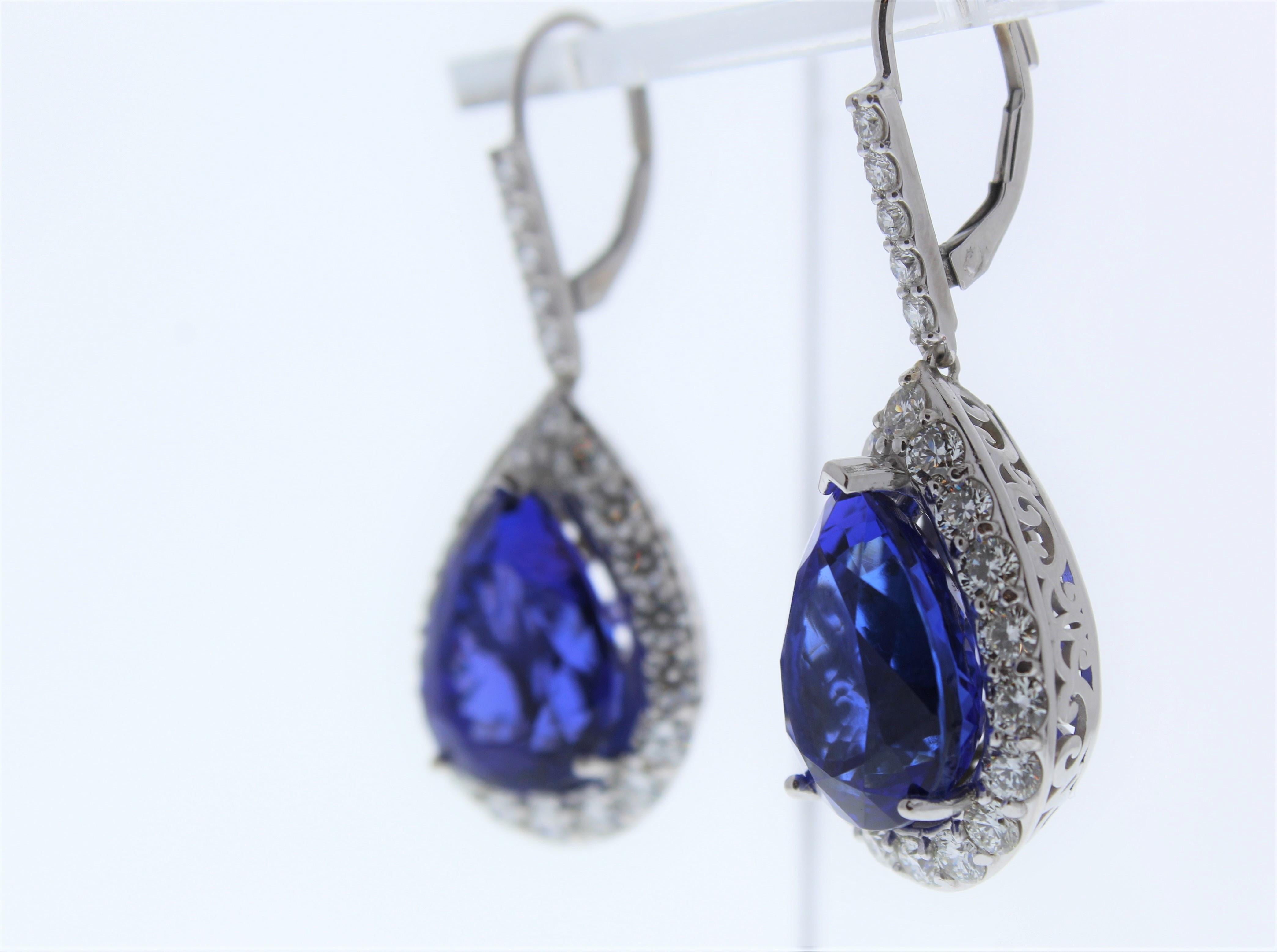 Make memories last forever by gifting these striking, brightly polished 18k white gold raindrop dangle earrings to your beloved on a birthday, anniversary, or holiday occasion. Two pear-shaped fine quality tanzanites are prong set on the bottom of