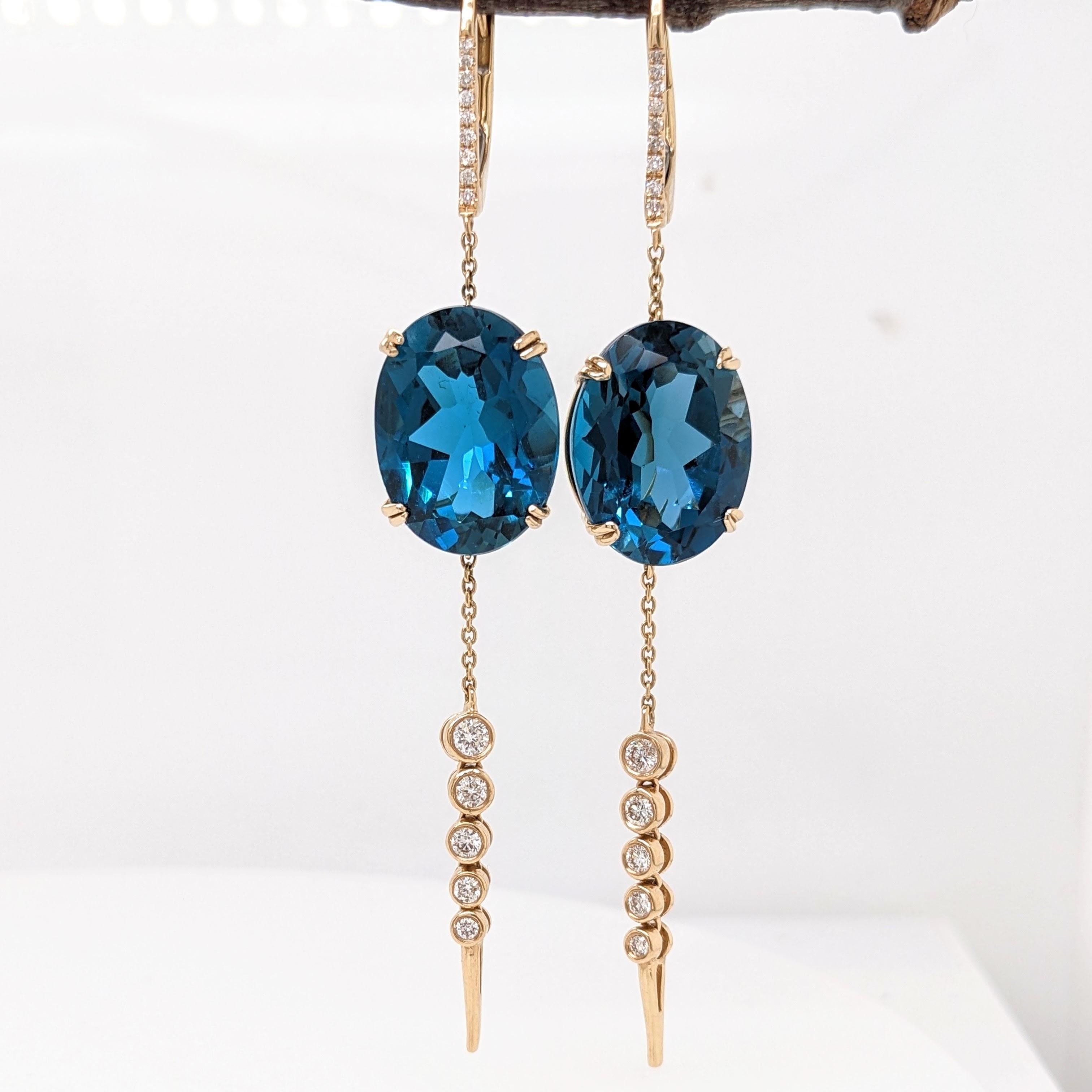 These gorgeous show-stopper earrings boast a pair of stunning london blue topaz, strung together in 14k yellow gold with natural diamonds for an elegant sweeping look. A great option to elevate any evening wear and turn heads wherever you go!