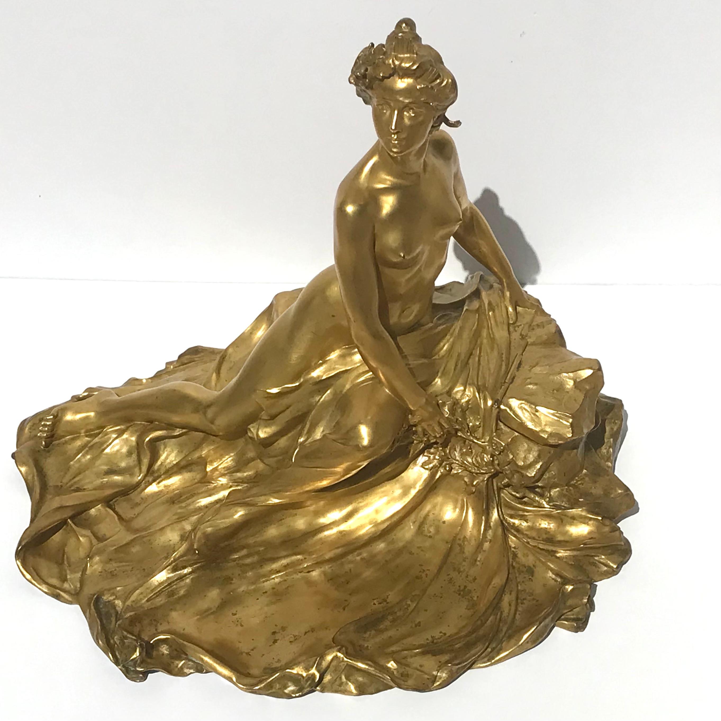Raoul Larche (1860-1912) Monumental Inwell vide pouch.
'L'Idée, Allégorie sur un Rocher' A Gilt-Bronze Inkwell, circa 1900
Figural Centerpiece, Inkwell and vide pouch.
Gilt-bronze

Height 19 in.; Width 23 in.; Depth 18 in.
49 cm; 58.5 cm; 46