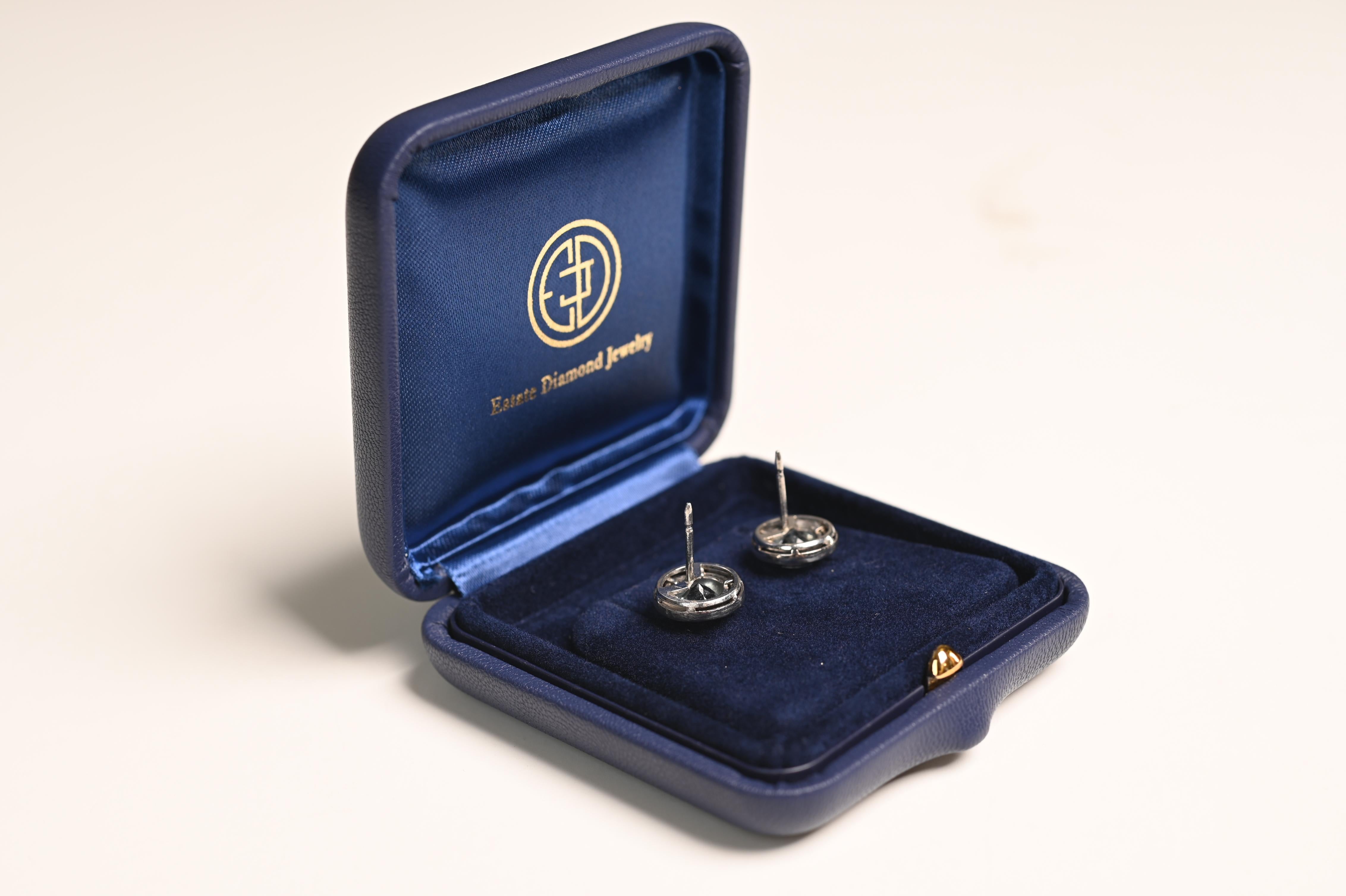 Presenting a stunning pair of gemstone earrings, meticulously crafted to captivate the eye. At the heart of each earring sits a vibrant aquamarine, displaying a rich, ocean-blue hue that radiates both depth and clarity. The aquamarines are elegantly