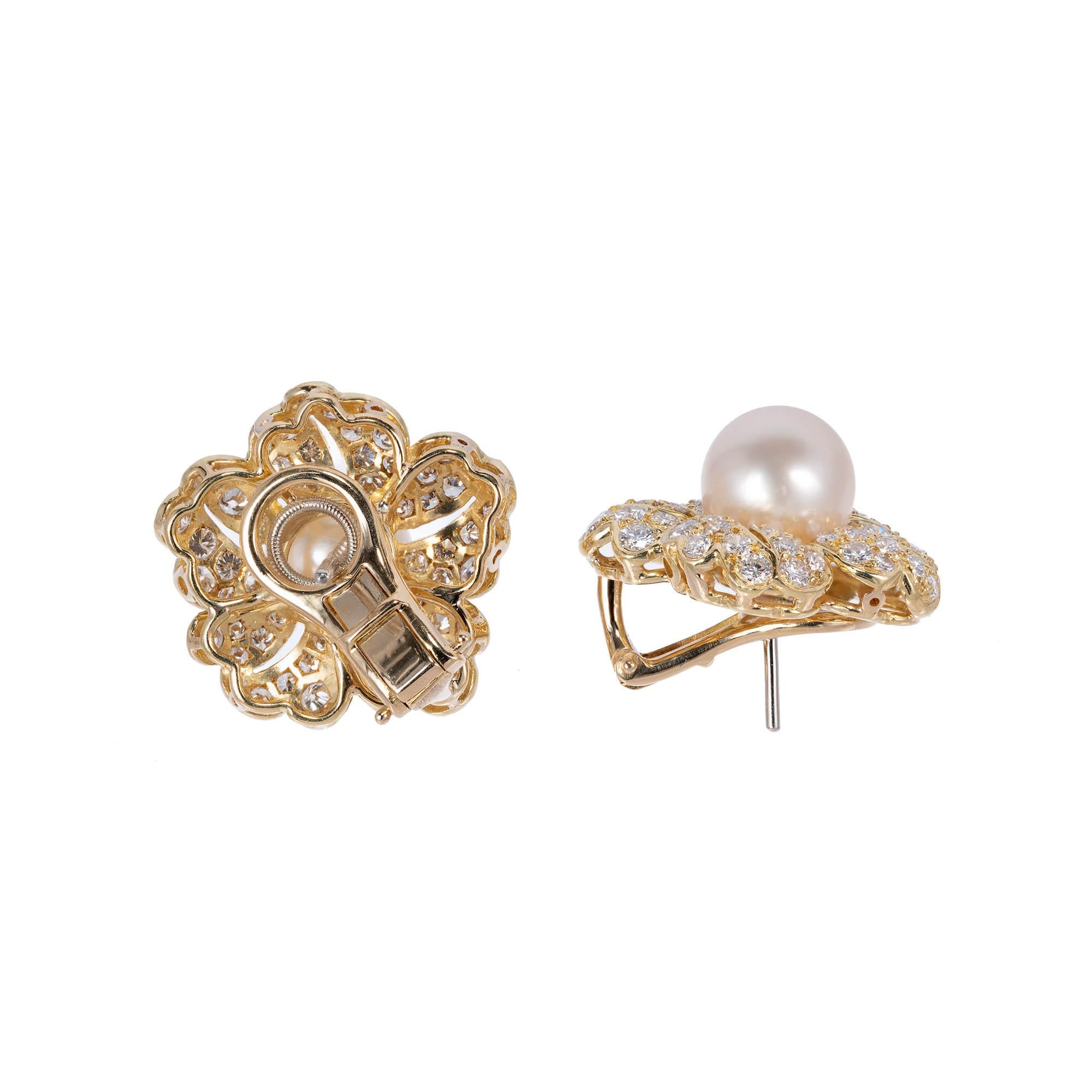 Cultured pearl and diamond clip post earrings in 14k yellow gold earrings. diamond flower design with 2 round pearl centers. clip post. 

2 cultured pearls 9.6-9.7mm
116 round brilliant cut F-G VVS-VS diamonds Approximate 2.30 carats 
14k Yellow