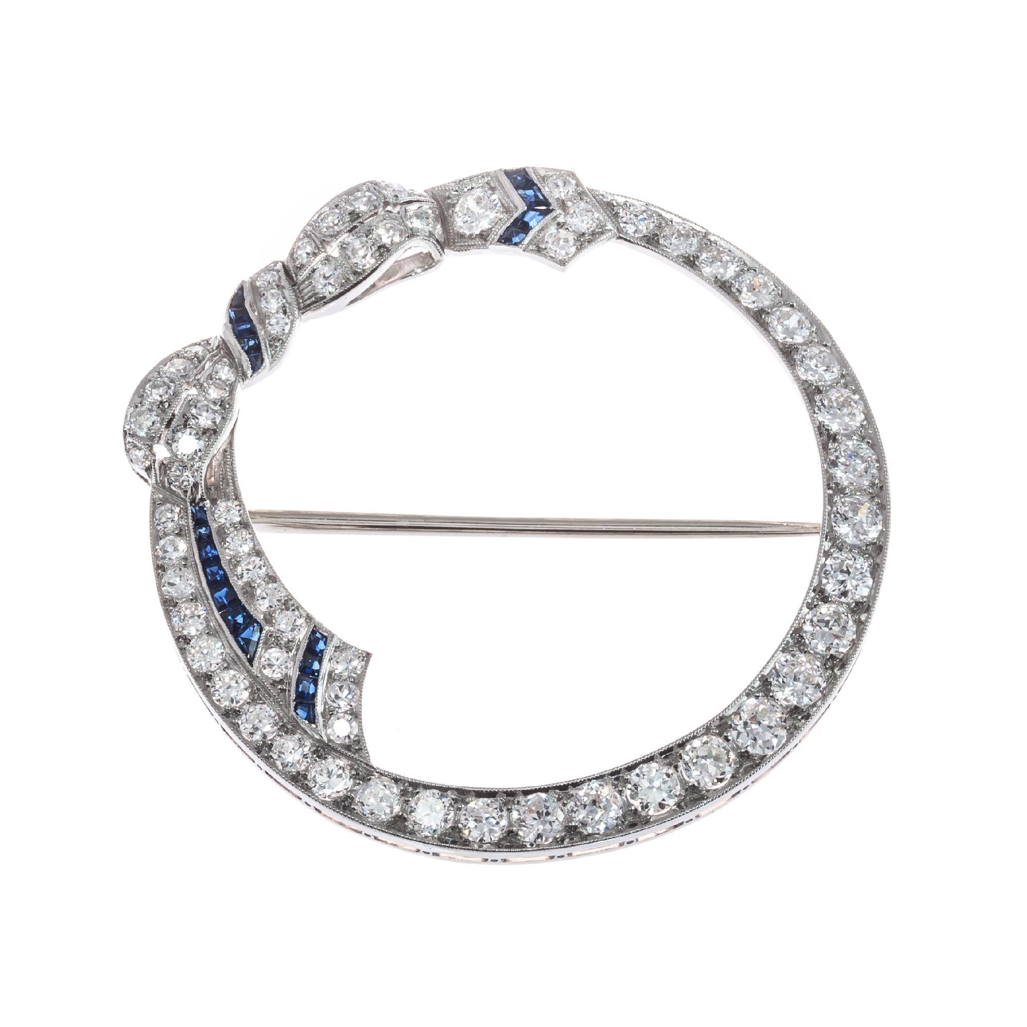 Diamond and sapphire bow open circle brooch. Platinum circle with 14k white gold stem and catch. Bright sparkly old European cut diamonds with square cut accent sapphires. 

63 old European cut H-I VS2-SI2 diamonds, Approximate 2.00cts 
20 square