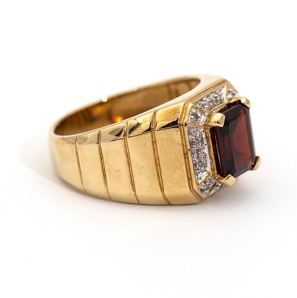 Handsomely crafted in 9 carat yellow gold is this aristocratic ring featuring a bold 2.30 carat emerald cut red garnet and is surrounded by a stately border of diamonds. We have named this vintage piece The Michael Ring.

The Michael Ring Gemstone