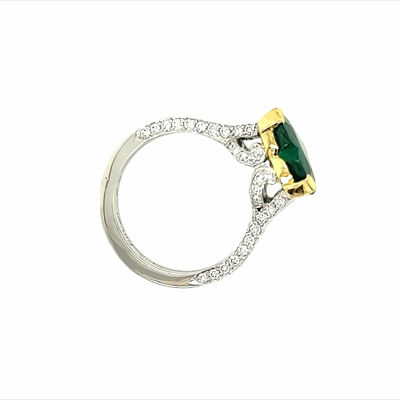 Dieser atemberaubende Ring ist ein wahres Kunstwerk mit einem wunderschönen herzförmigen Smaragd, der etwa 2,30 Karat wiegt. Der Smaragd ist in eine wunderschöne Fassung aus Platin und 18 Karat Gelbgold gefasst, die den satten Grünton des Edelsteins