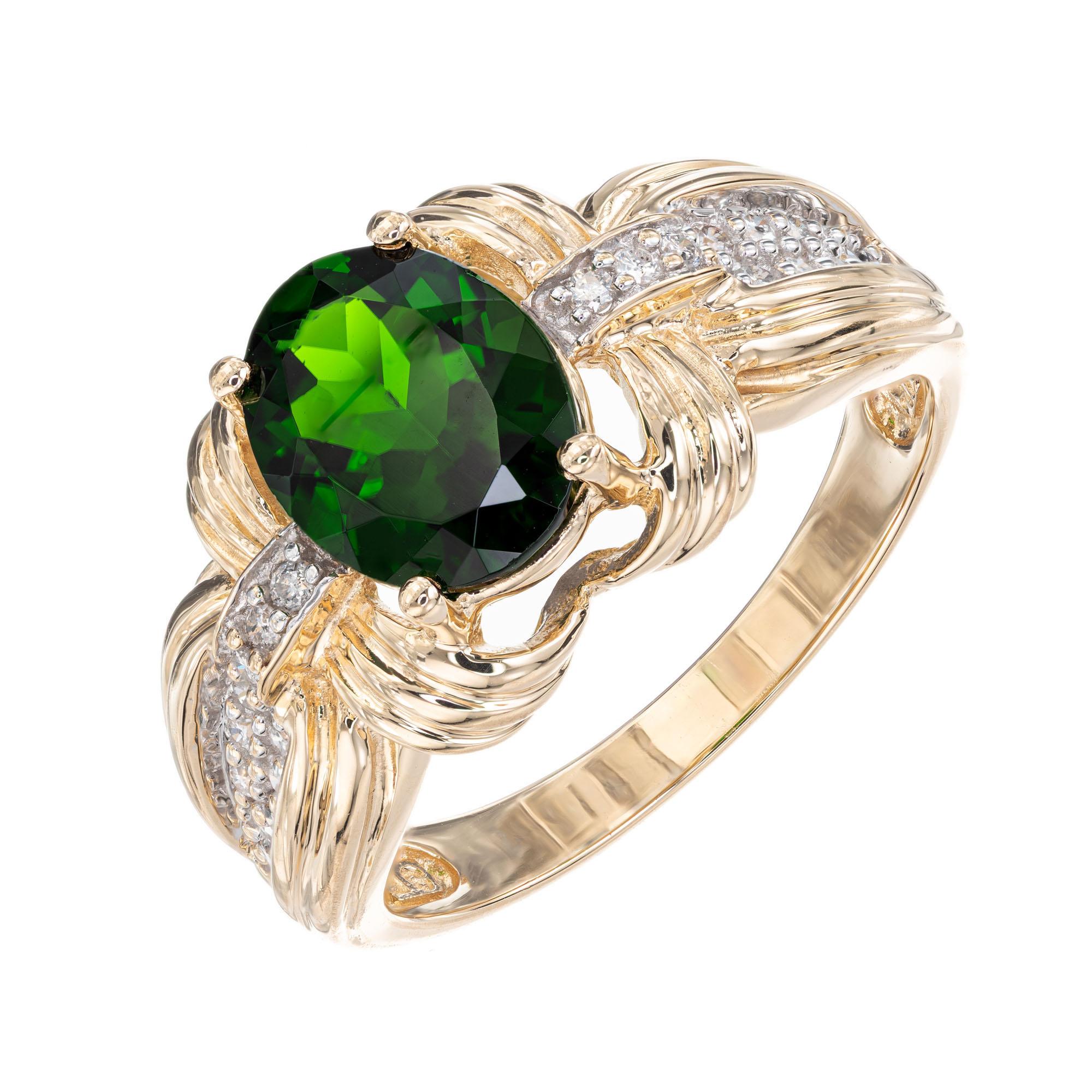 Tourmaline and diamond ring. Oval center green tourmaline with 24 full cut accent diamonds in a 14k yellow gold setting. 

Top gem bright green Tourmaline approx. total weight 2.30cts, 9 x 7mm
24 full cut diamonds approx. total weight .20cts, H,