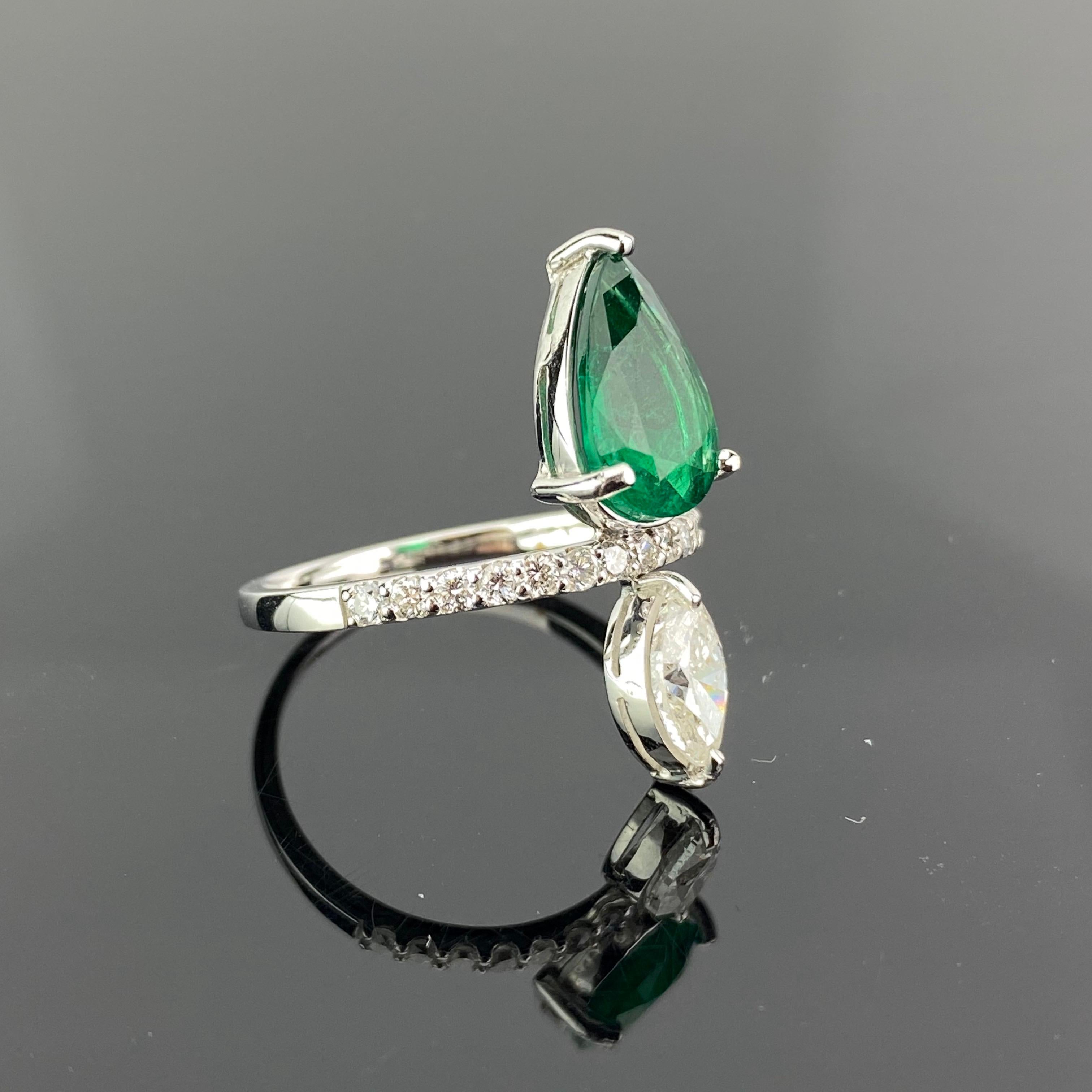 A modern, yet classic 2.30 carat  Zambian Emerald and 0.73 carat Diamond Marquise ring, attached to a Diamond band. The emerald is transparent with great lustre and colour, with few inclusions. All set in 18K white gold. Currently a ring size US 7,