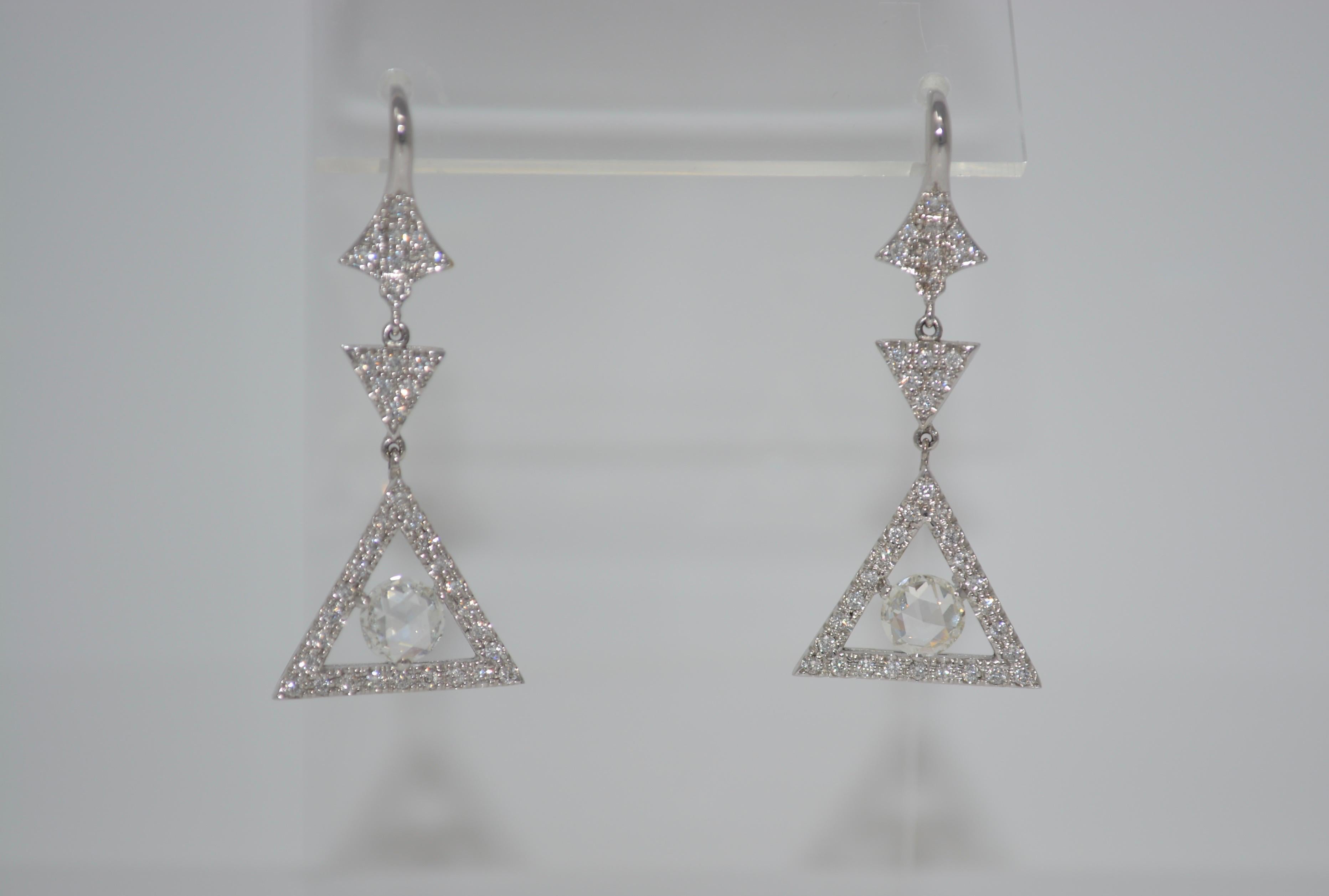 These Lovely and detailed earrings are classy and wearable. They are made in 18K white gold and features two rose cut diamonds 0.80 carat each total of 1.60 carat  with F G color and VS clarity  set in the center of diamond studded triangles  which