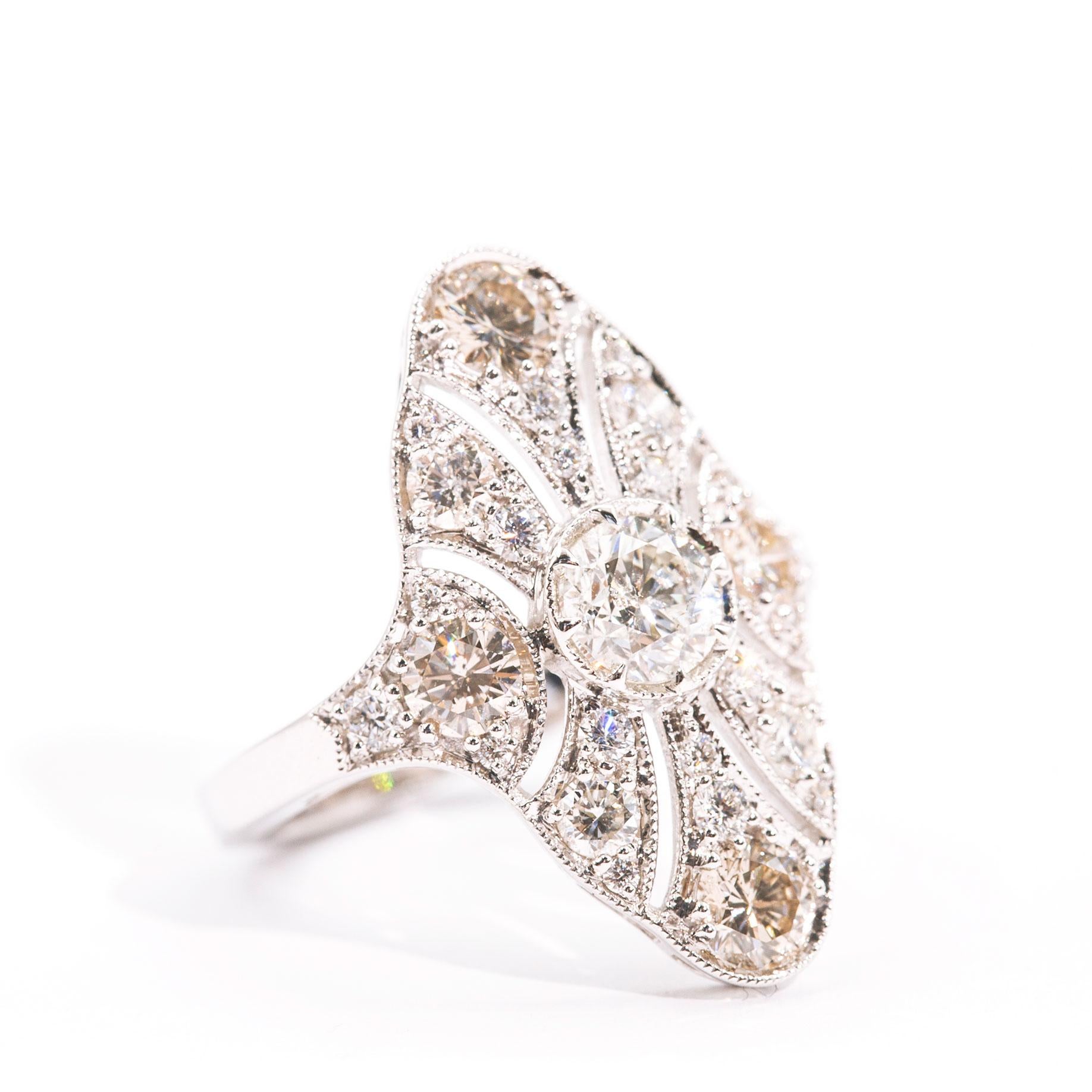 Forged in 18 carat white gold, this antique inspired cluster ring features a sparkling 0.71 carat certified round brilliant cut diamond in the centre of a glimmering gallery of round brilliant cut diamonds totalling 1.59 carats. We have named this