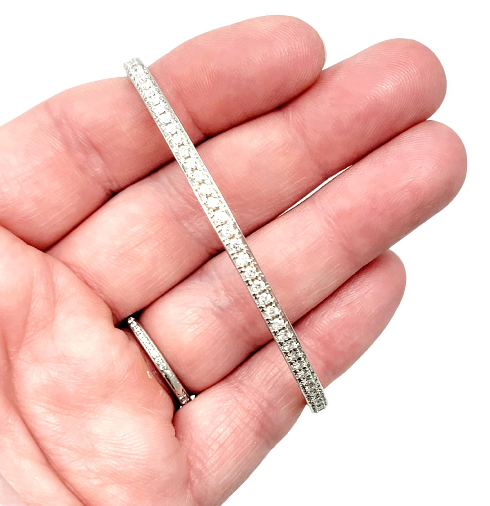 Simple yet stunning diamond eternity bracelet. This delicate paved bangle bracelet boasts an ultra feminine feel, while the sleek simplicity gives it a modern elegance. It features 91 natural round brilliant diamonds, H-I in color and SI-I2 in