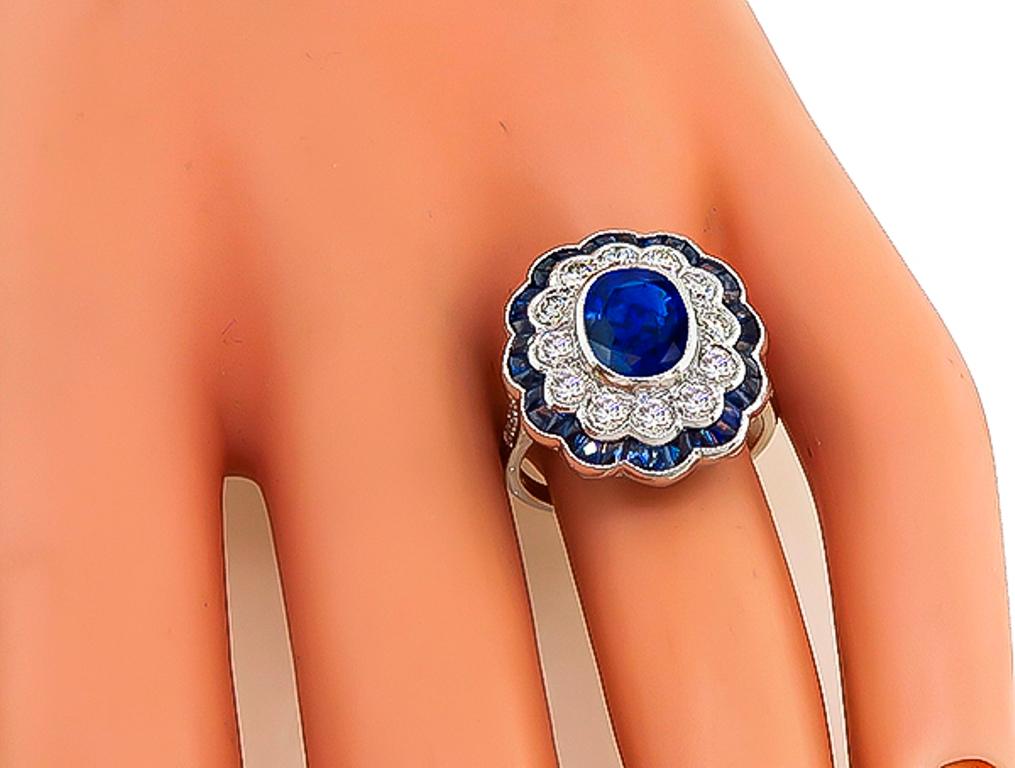 This elegant 18k white gold ring is centered with a lovely oval cut sapphire that weighs approximately 2.30ct. The center stone is accentuated by sparkling round cut diamonds weighing approx 1.13ct graded G color with VS clarity and faceted cut