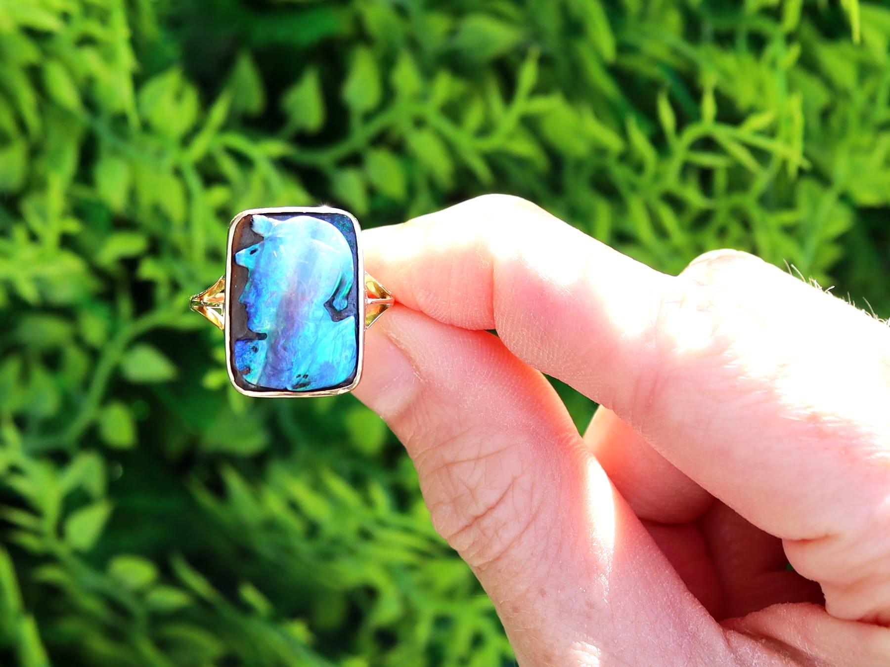 A stunning, fine and impressive antique 2.30ct black opal and 18k yellow gold cameo ring; part of our diverse antique opal jewelry and estate jewelry collections. 

This stunning, fine and impressive antique opal ring has been crafted in 18k yellow
