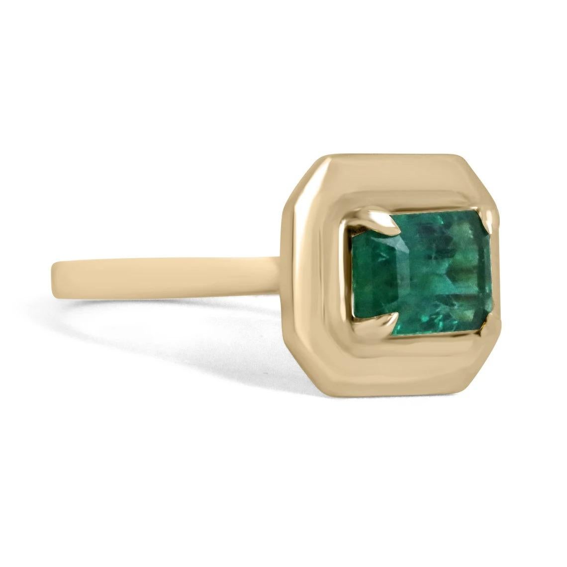 A stylish solitaire emerald ring that showcases an exquisite emerald-cut emerald set east to west. The gemstone displays the most beautiful rich forest green color with very good transparency and luster. Set in a four-prong claw setting, crafted in