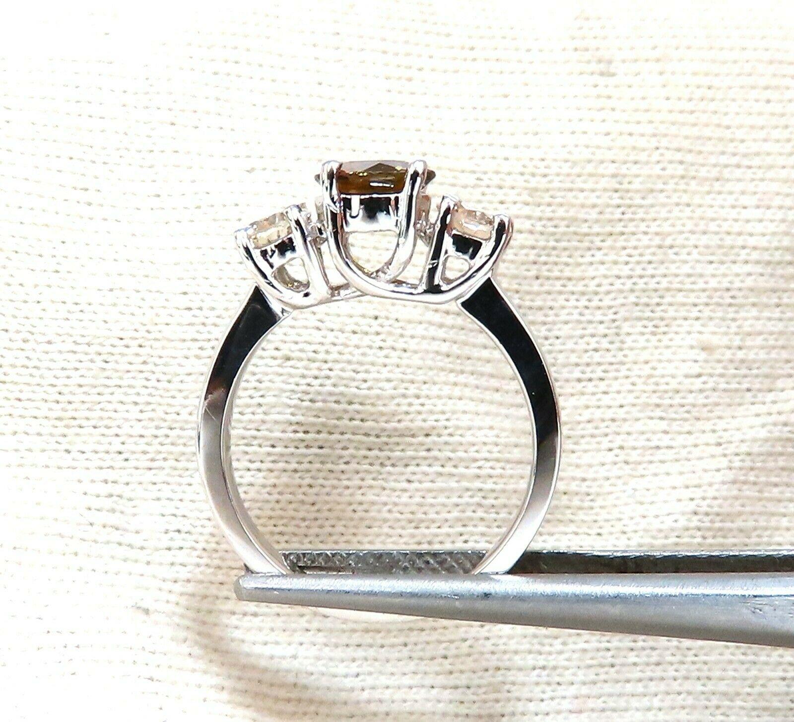 Classic Diamonds & Sapphire, Three Stone Ring

1.30ct Round Natural Fancy Yellow Orange Brown Sapphire

Vibrant Vivid Cognac Color

Full cut and Full Faceted.

6.7mm diameter

1.00ct. Round Cut diamond

Full Cut Brilliant

Fancy Light Brown 

Si-2