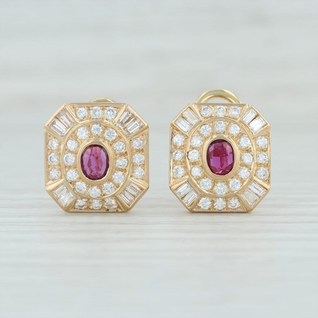 These gorgeous eye catching earrings feature sparkling diamonds creating a tiered halo design which frame genuine rubies. The deep red rubies have a nice color contrast with the white diamonds. The precious gems are set in yellow gold and secure