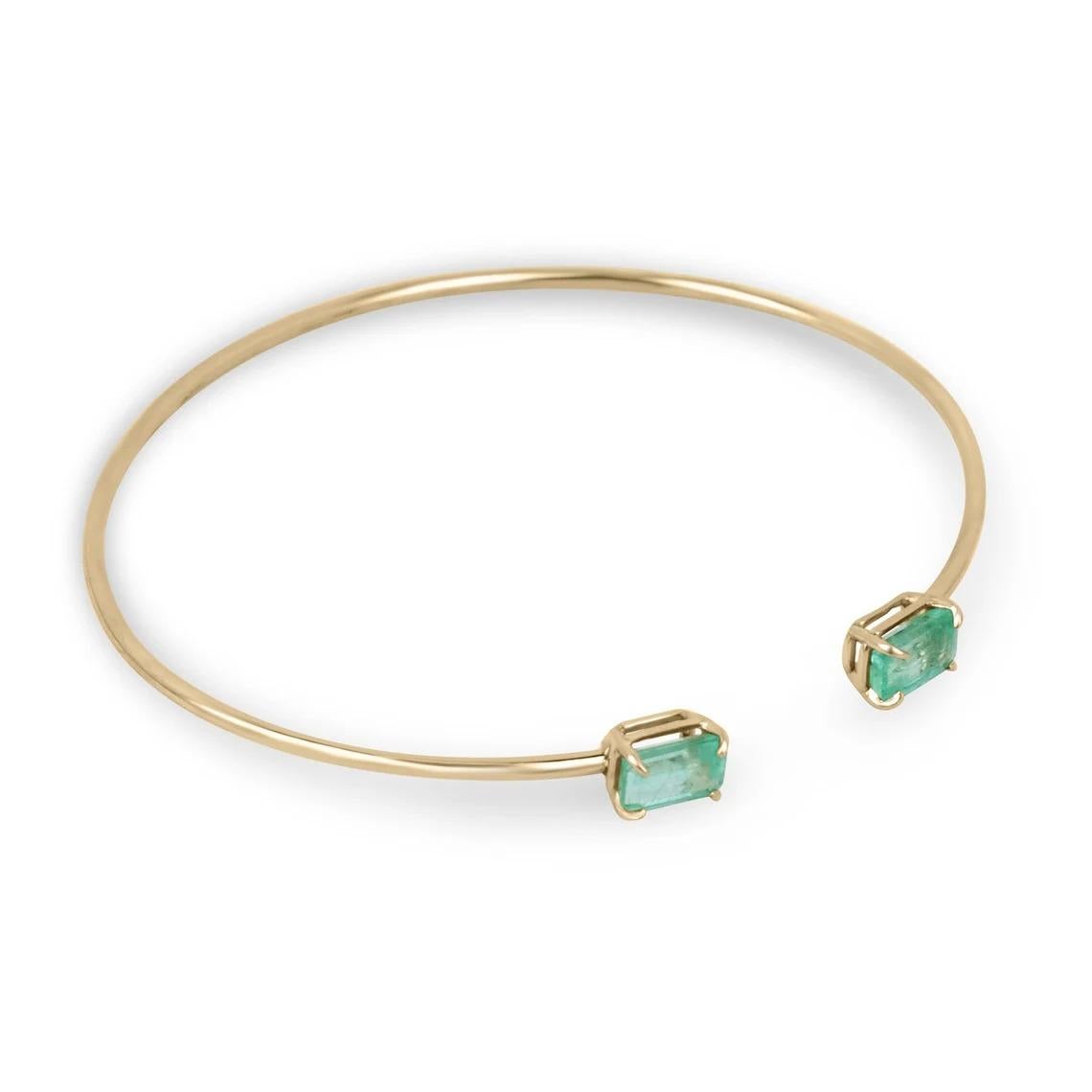 The toi et moi cuff bangle bracelet is a stunning piece of jewelry that symbolizes the intertwining of two individuals. This exquisite bracelet features two emerald cut emeralds, weighing a total of 2.30 carats, set in a four claw prong setting. The
