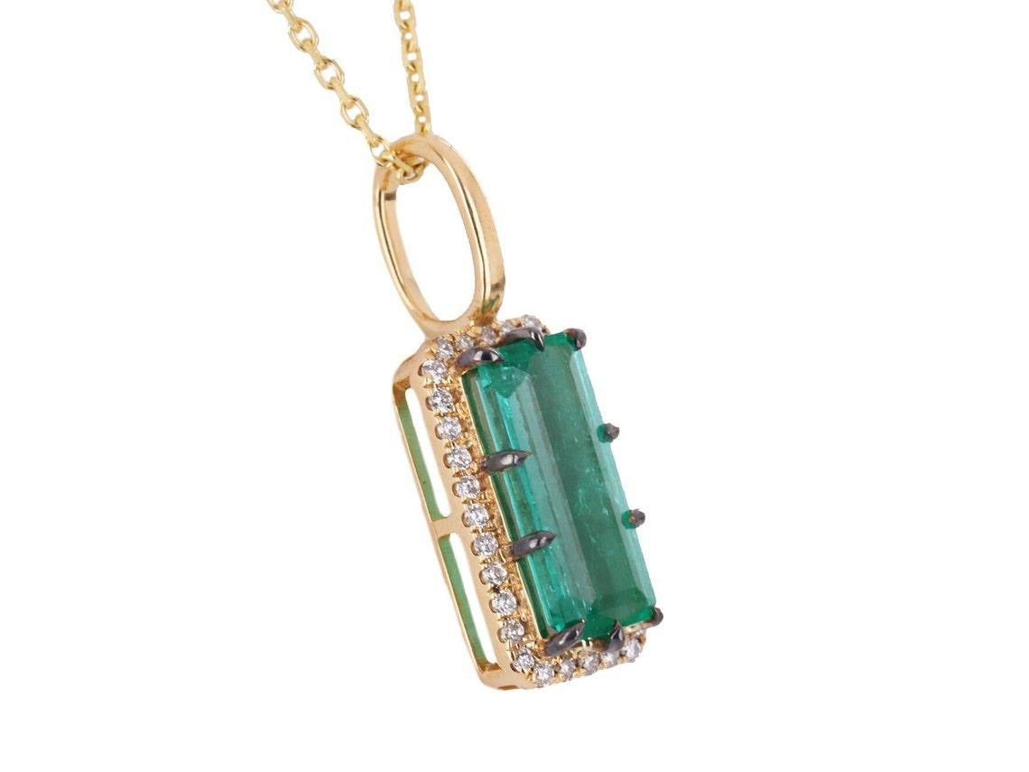 Take a peek at this stunning emerald and diamond halo pendant. The center stone carries 2.0-carats of pure natural emerald beauty! Displaying a vivid green color, and excellent luster. This large stone is accented by a diamond halo. Set in 18K
