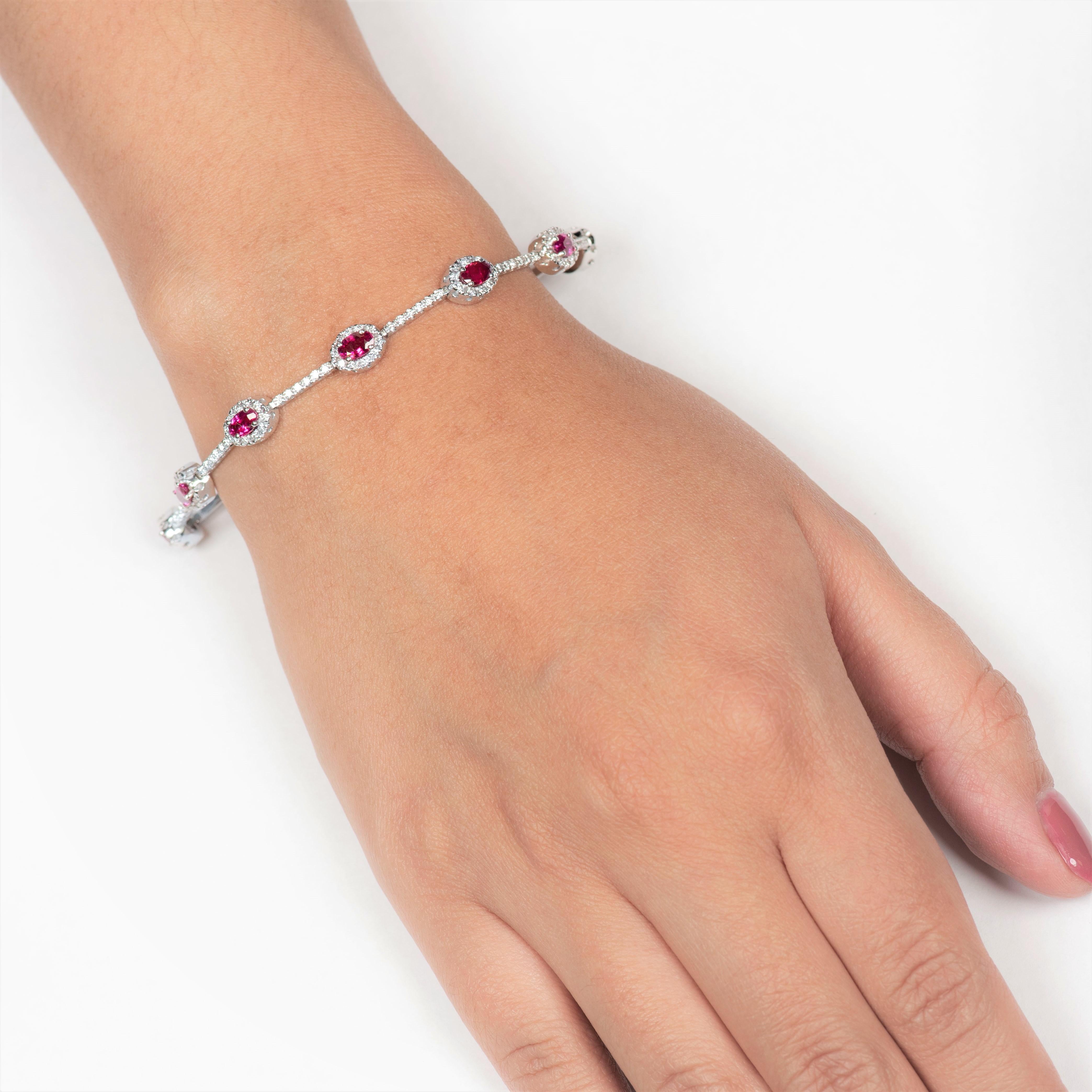 Elegant 2.31 carats of 10 perfectly matched oval cut Burma rubies encircled with 1.85 carats of round diamonds (180 diamonds). The bracelet measures 7 inches in length and is set in 14K white gold.

Diamond quality:  F-G color, VS2- SI1 clarity