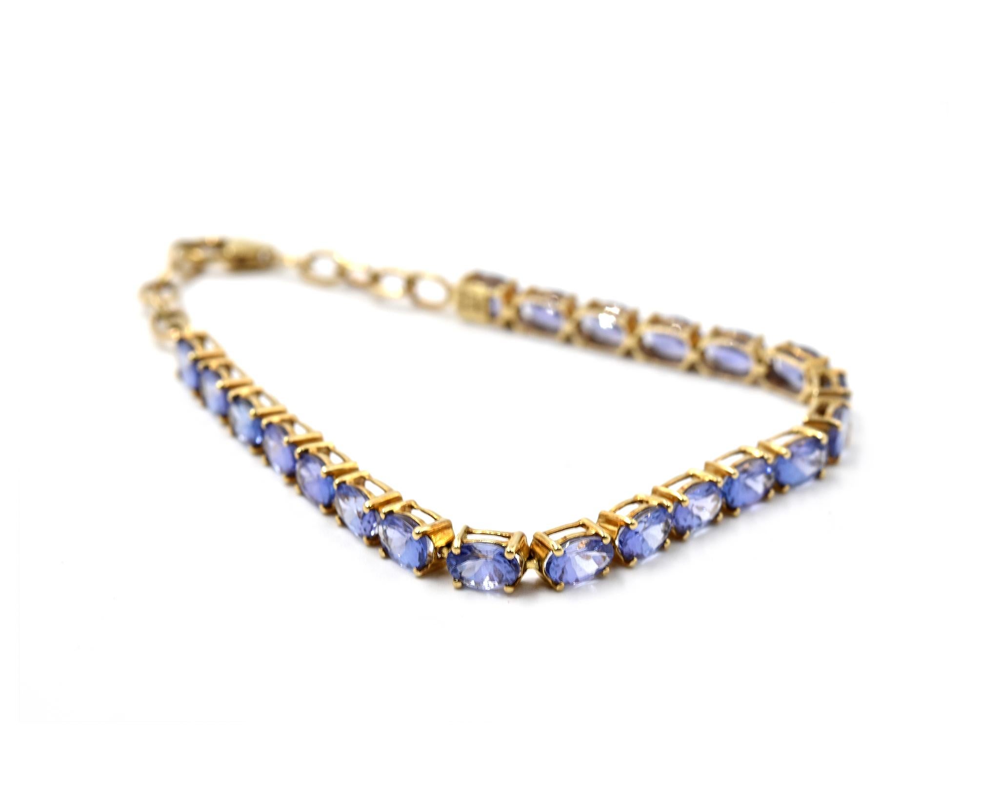Designer: custom design
Material: 10k yellow gold
Tanzanite: 21 oval cut = 2.31 carat total weight
Dimensions: bracelet is 7 1/4-inch long and 1/8-inch wide 
Weight: 6.99 grams
