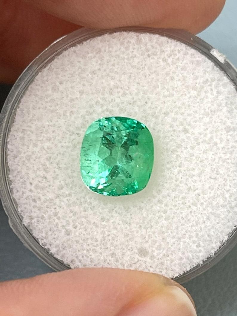 Stone: Emerald
Weight: 2.31-carats
Shape: Cushion Cut
Clarity: Transparent
Luster: Excellent
Color: Medium Light Yellowish Green
Measurements: 8.53mm x 7.94mm x 6.09mm
Geographic Origin: Colombia
Treatment: Natural, Oiling

Comments: Due to their