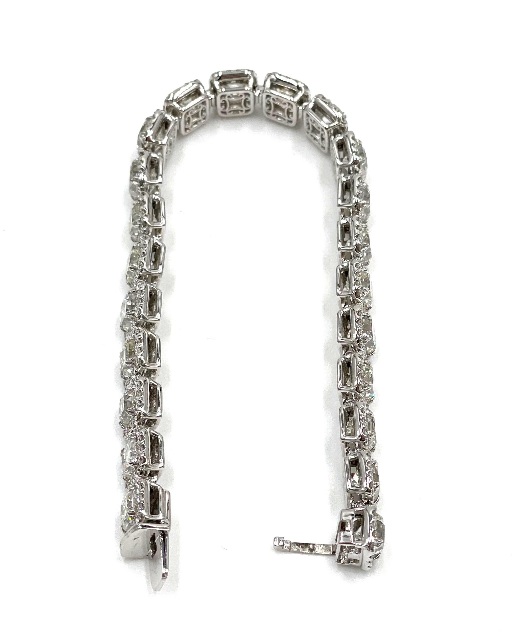 18K white gold diamond bracelet features 22 radiant cut diamonds totaling 20.04 carats (I/J color, VS/SI clarity) and 360 round brilliant-cut diamonds totaling 3.06 carats (G/H color, VS/SI clarity).

-Hidden safety clasp
-6.75 inches long
-30.8