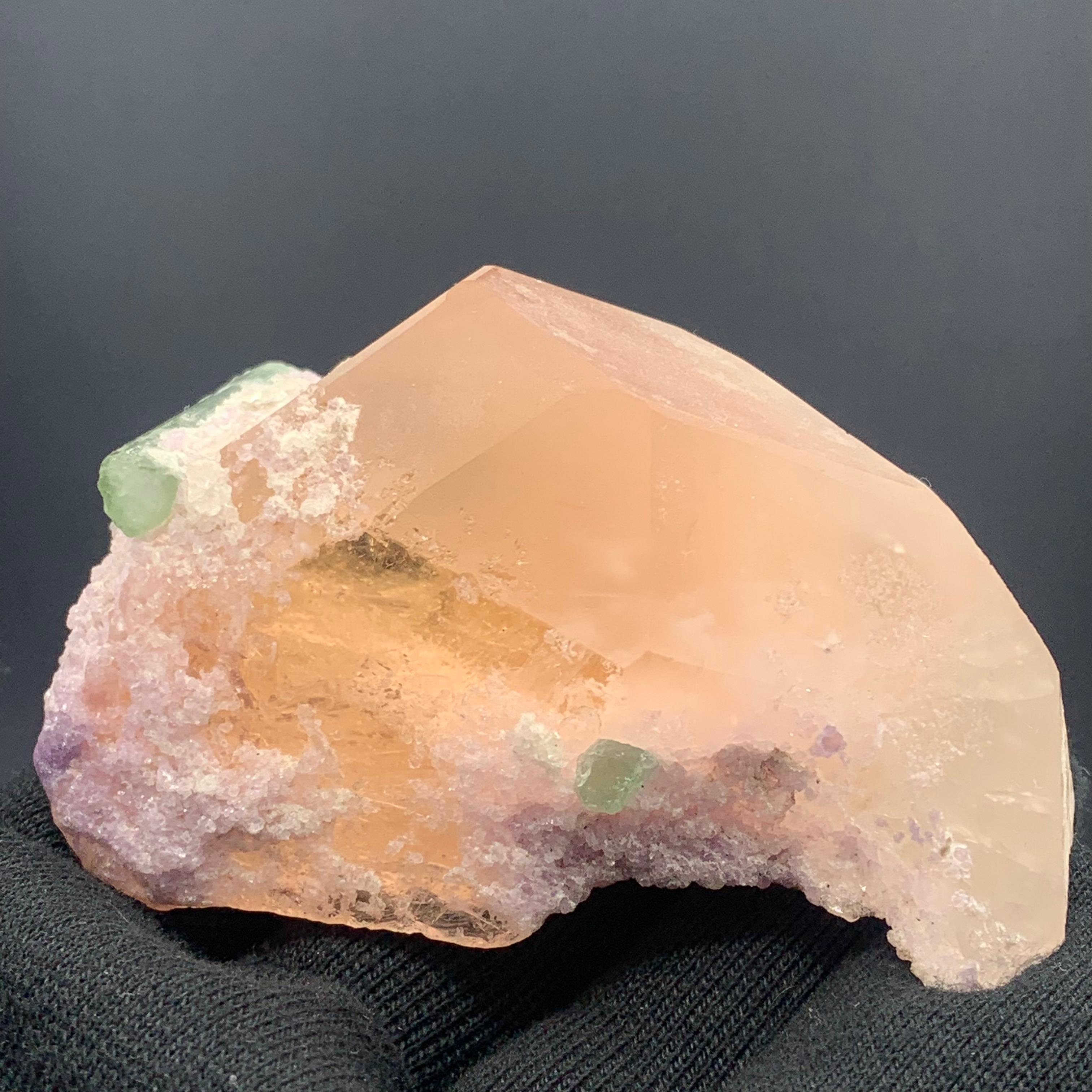 231.5 Gram Morganite Specimen attached With Green Tourmaline And Fluorite 

Weight: 231.5 Gram
Dimension: 4.3 x 8.3 x 5 Cm 
Origin: Kunar, Afghanistan 

With its soft pinkish hue, morganite is often associated with innocence, sweetness, romance and