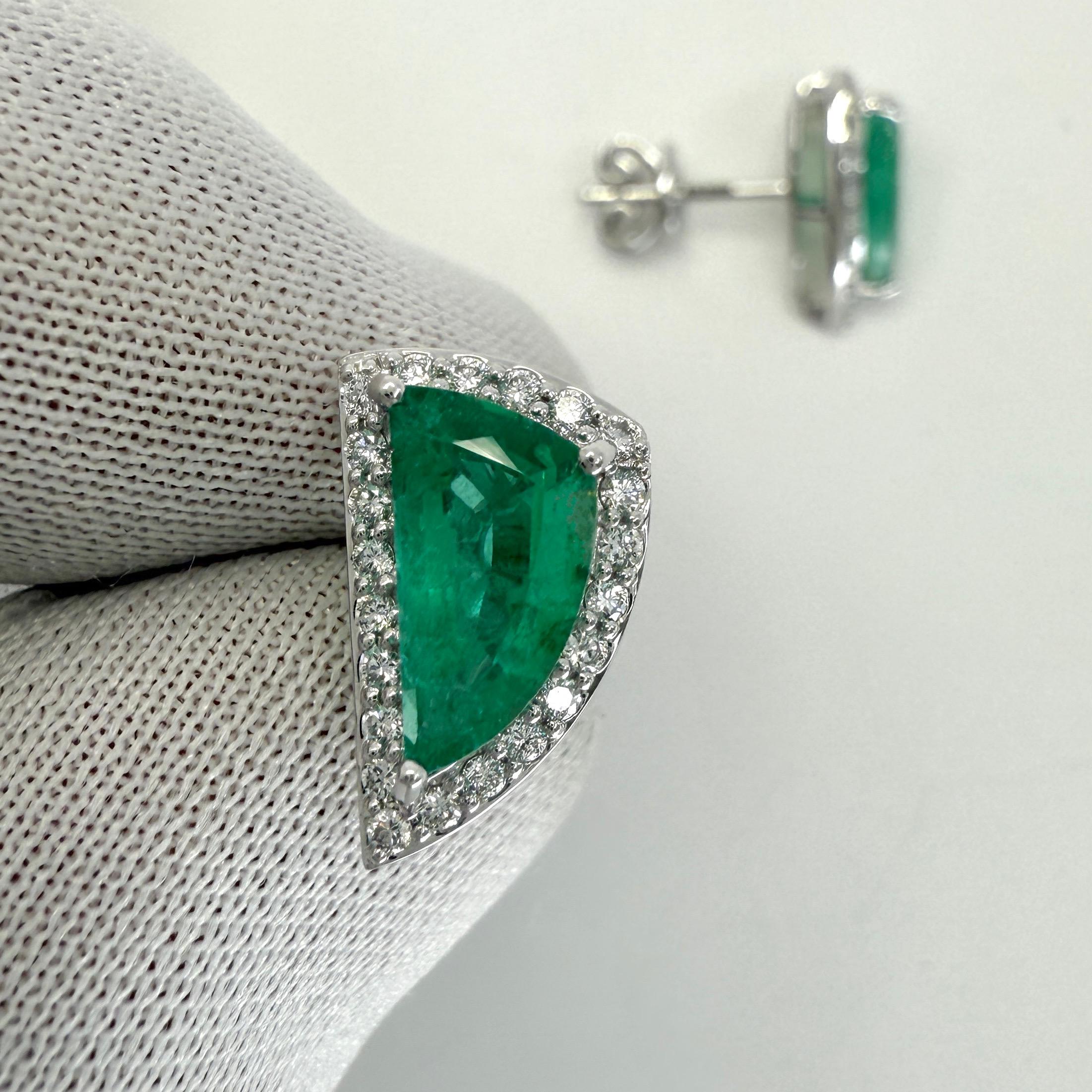 Natural Vivid Green Fancy Cut Emerald And Diamond 18k White Gold Halo Earring Studs. 2.31 Carat total.

These earrings feature two fine natural emeralds with a vivid green colour and an excellent fancy cut measuring 10x5.3mm. Approx. 2 Carat