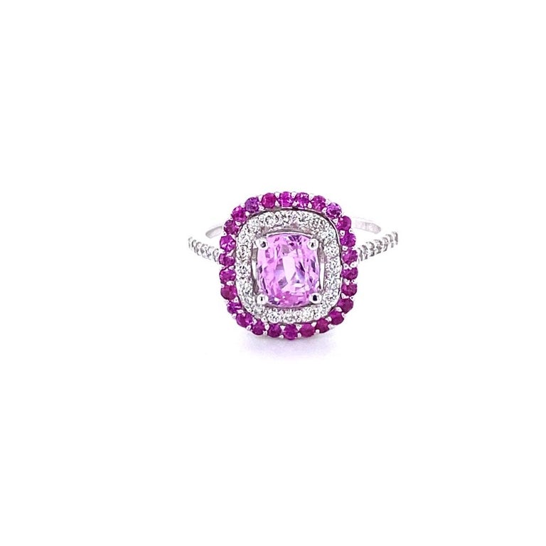 Simply the most elegant and beautiful Pink Sapphire and Diamond Engagement or Wedding Ring!

The center Cushion Cut Pink Sapphire is 1.47 Carats and is surrounded by a halo of 36 Round Cut Diamonds with a carat weight of 0.41 Carats (Clarity: VS,