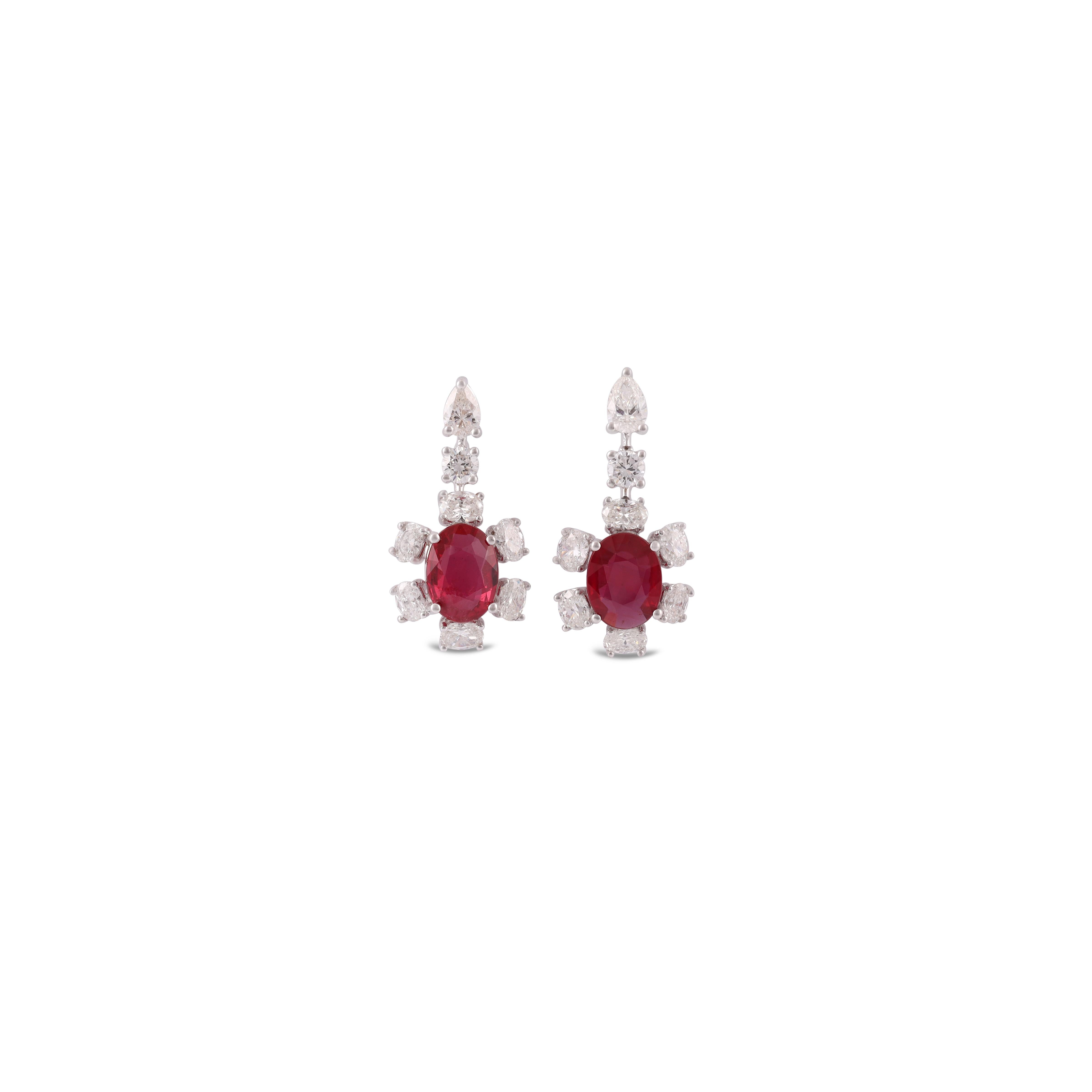 This is an elegant Natural Mozambique Pigeon Blood Ruby & diamond Earring studded in 18k White gold with 2 piece of oval Cut  shaped Mozambique Ruby weight 2.32 carat With 14 pieces of round shaped diamonds weight 1.67 carat, & 2 pieces of Pear