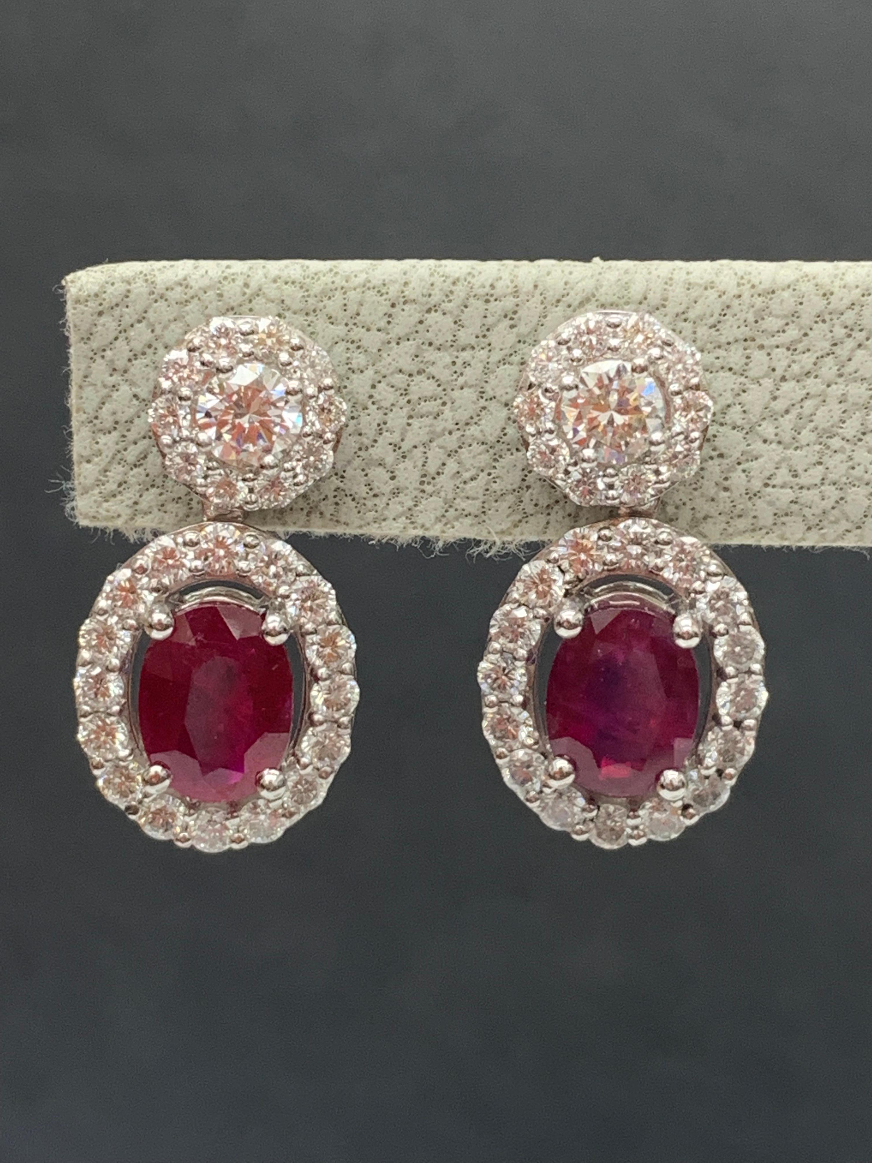 A beautiful and chic pair of drop earrings showcasing brilliant-cut diamonds, and oval-shaped Rubies set in an intricate and stylish design. 2 Diamonds on the top weigh 0.37 carats in total.  2 Rubies weigh 2.32 carats in total. Made in 18k white