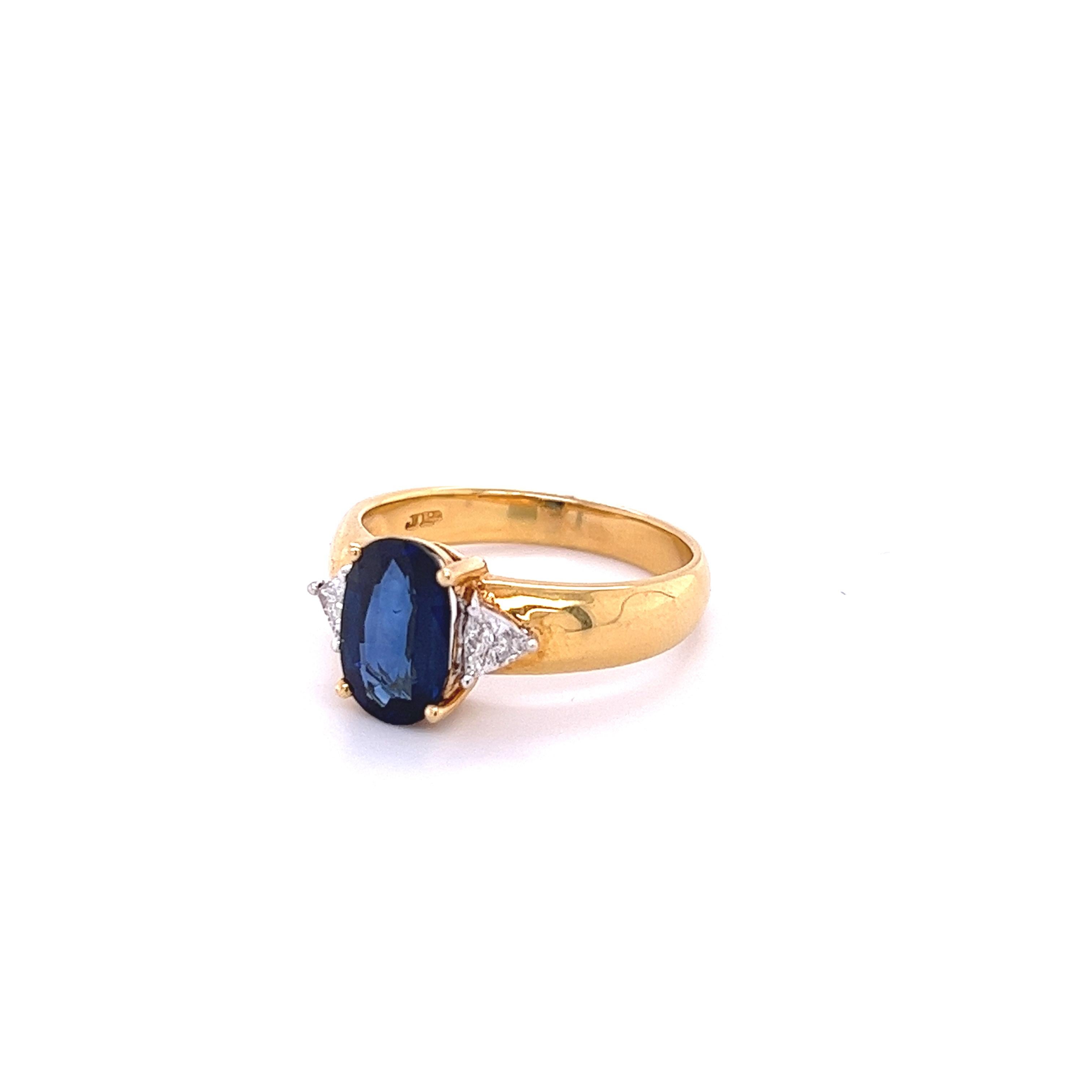 2.32-carat oval cut Blue Sapphire set with 2 trillion cut diamond accents in a 18k yellow gold ring. A simple and elegant ring setting allows for a stunning deep blue sapphire to do all the talking. 

Double Rhodium plated for a long-lasting shine.